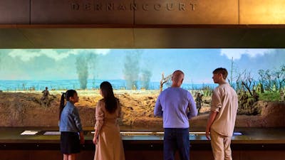 A group of people looking at the Dernancourt Diorama at the Australian War Memorial