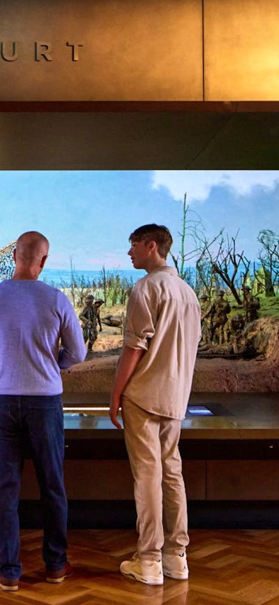 A group of people looking at the Dernancourt Diorama at the Australian War Memorial