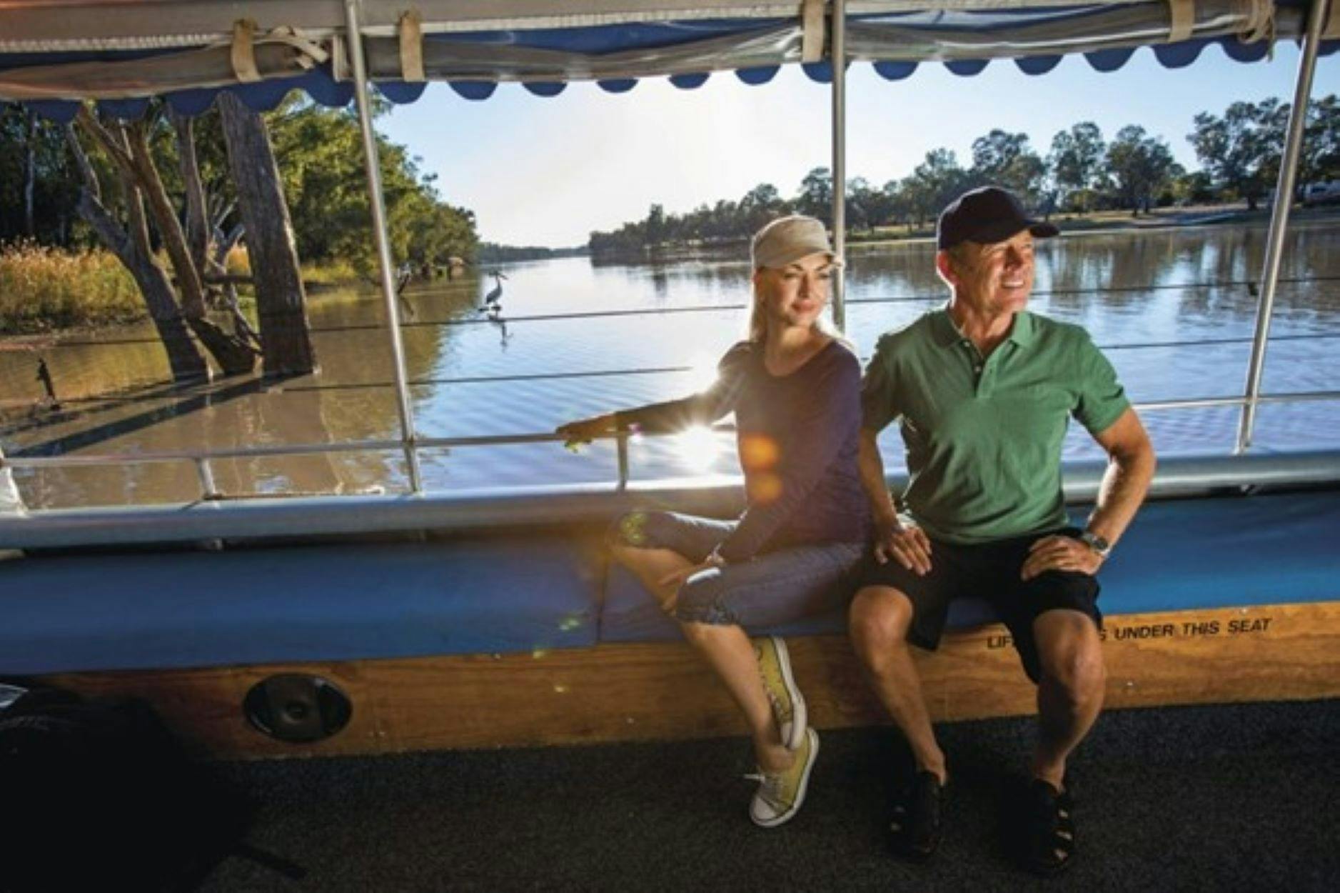 Man and Lady enjoying a cruise along the Balonne River.