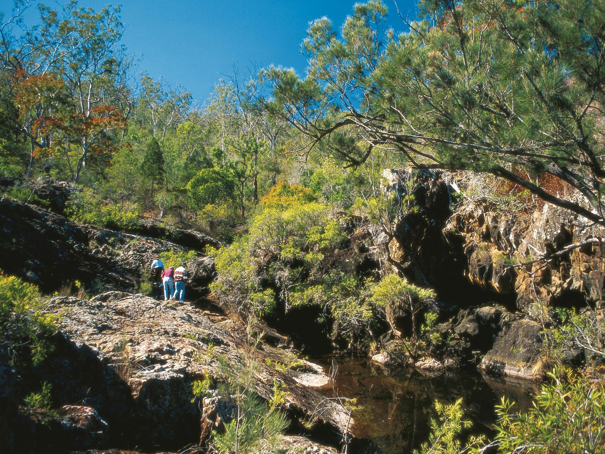Family exploring rocky outcrop, Kroombit Tops National Park Family exploring rocky outcrop, Kroombit Tops National Park
