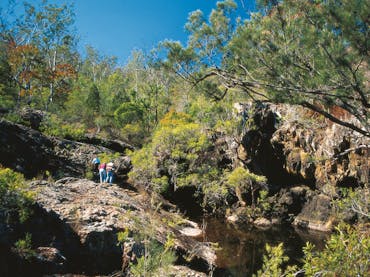 Family exploring rocky outcrop, Kroombit Tops National Park