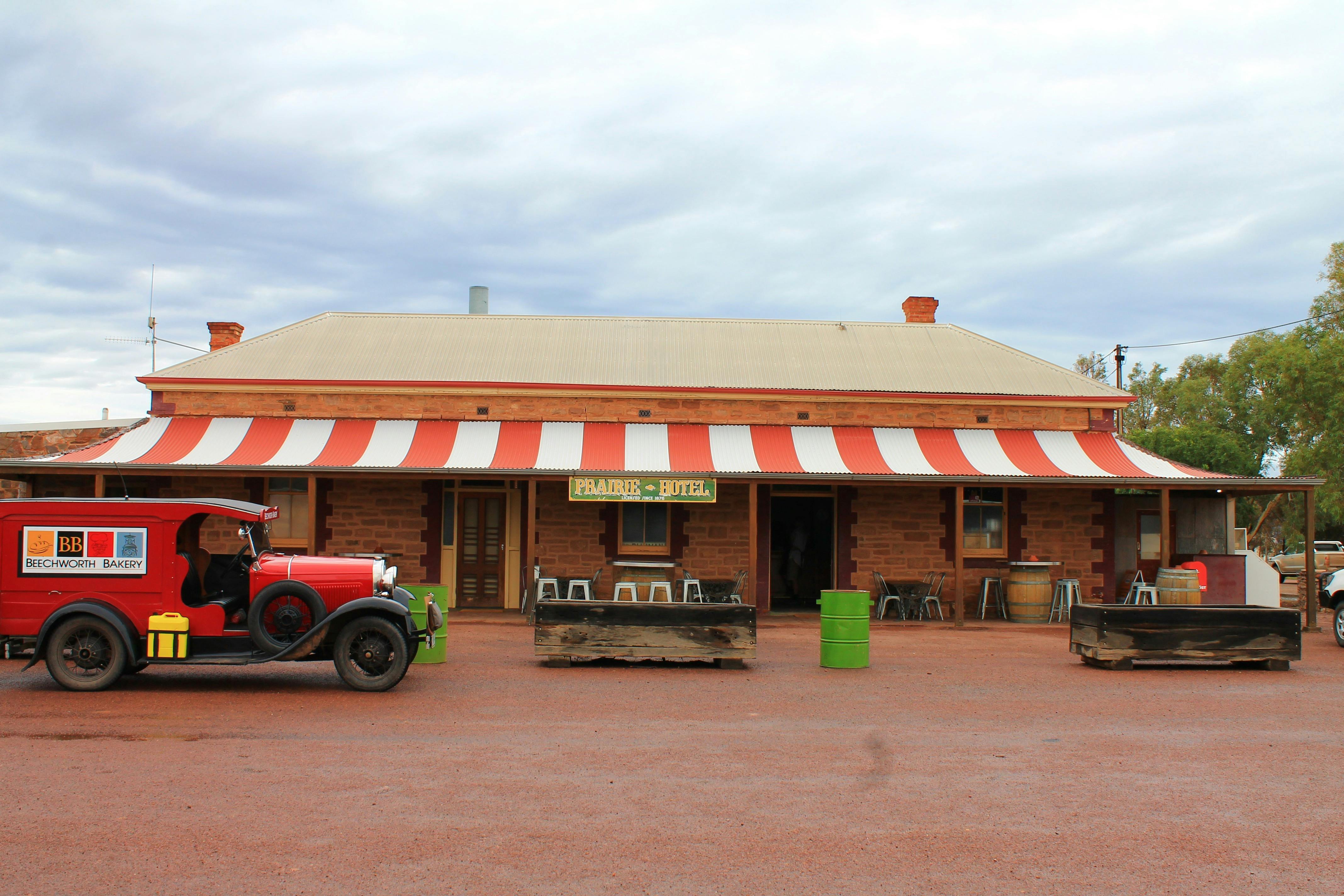 The exterior of the Prarie Hotel with its red and white striped shade