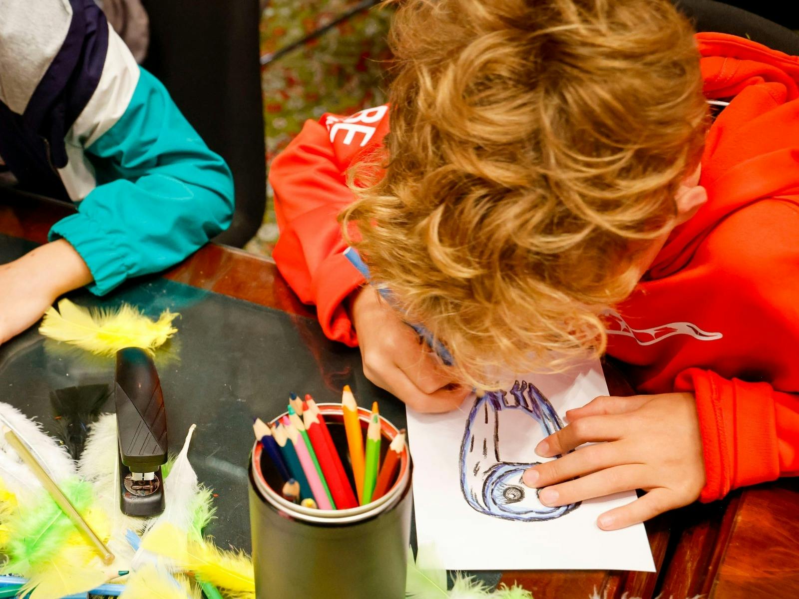 Child drawing an owl