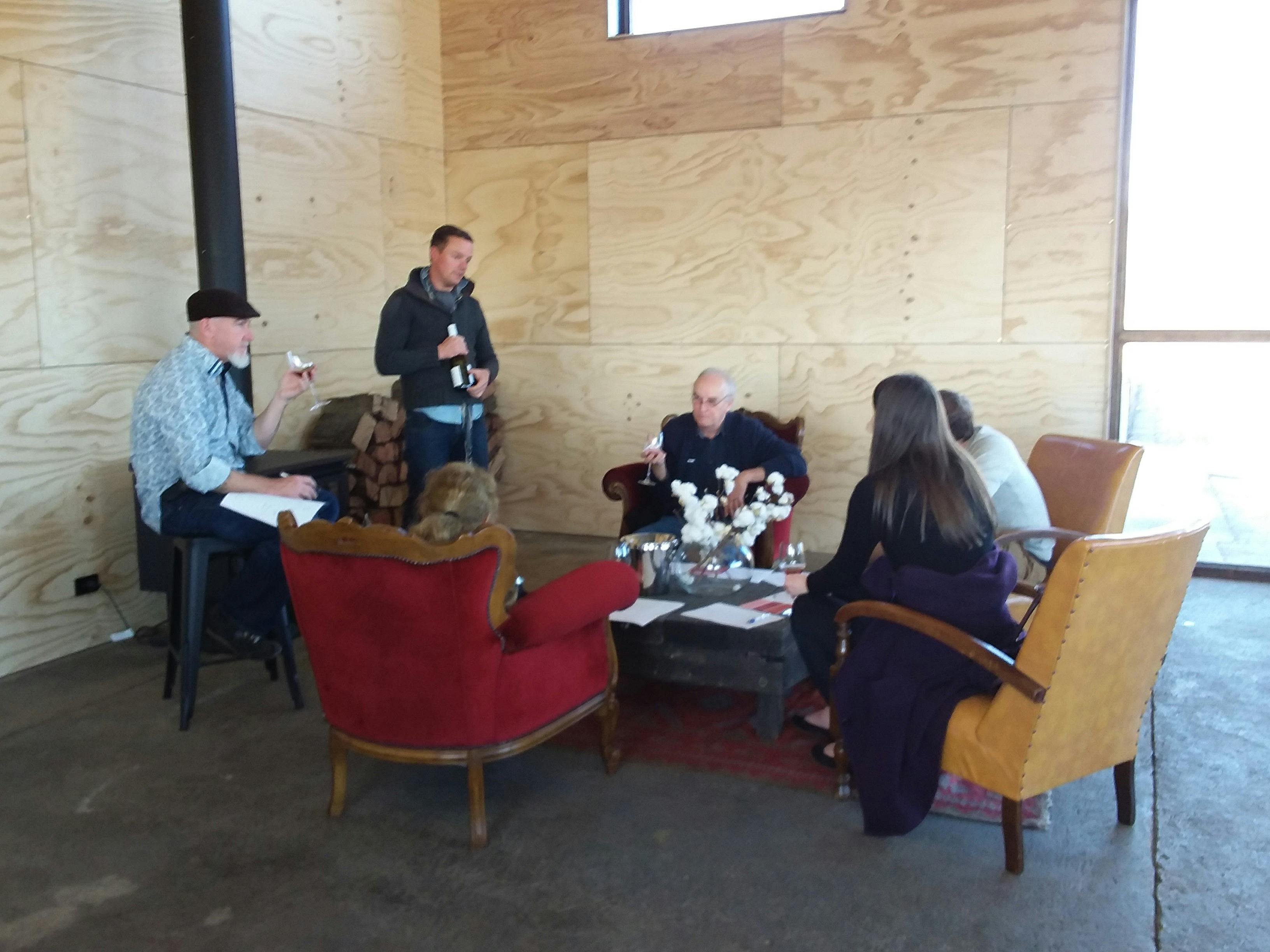 A small group enjoying wine tasting and learning about the wine with Nick