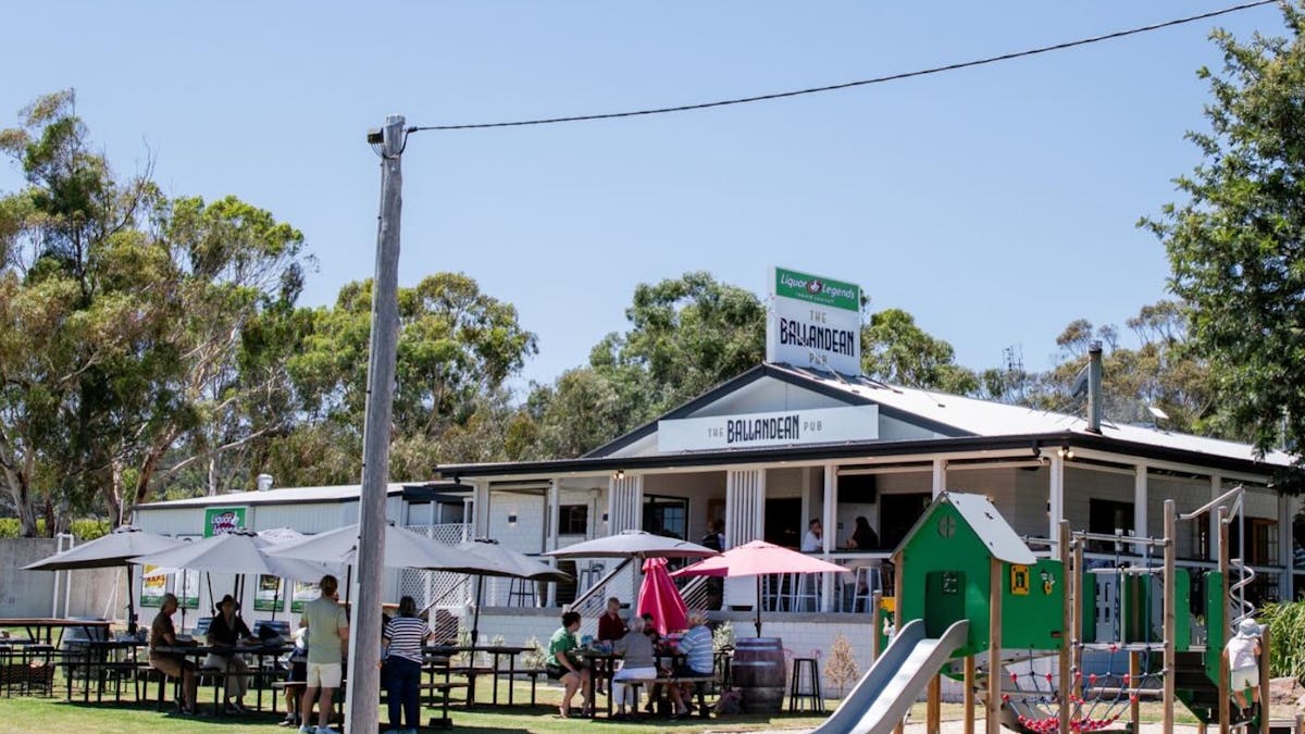 A sunny day with outdoor seating and kids playground at The Ballandean Pub