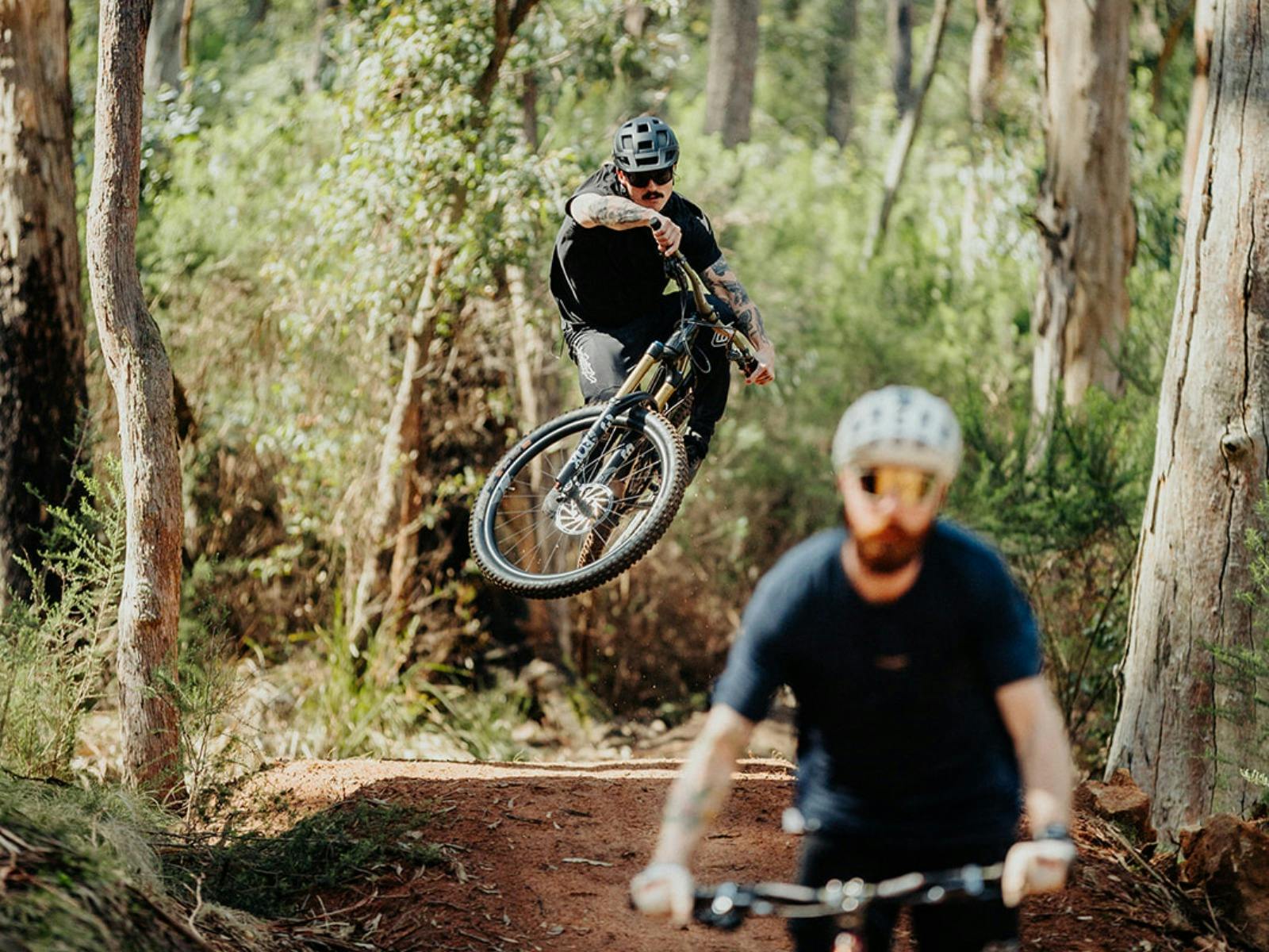 mountain bikers jumping