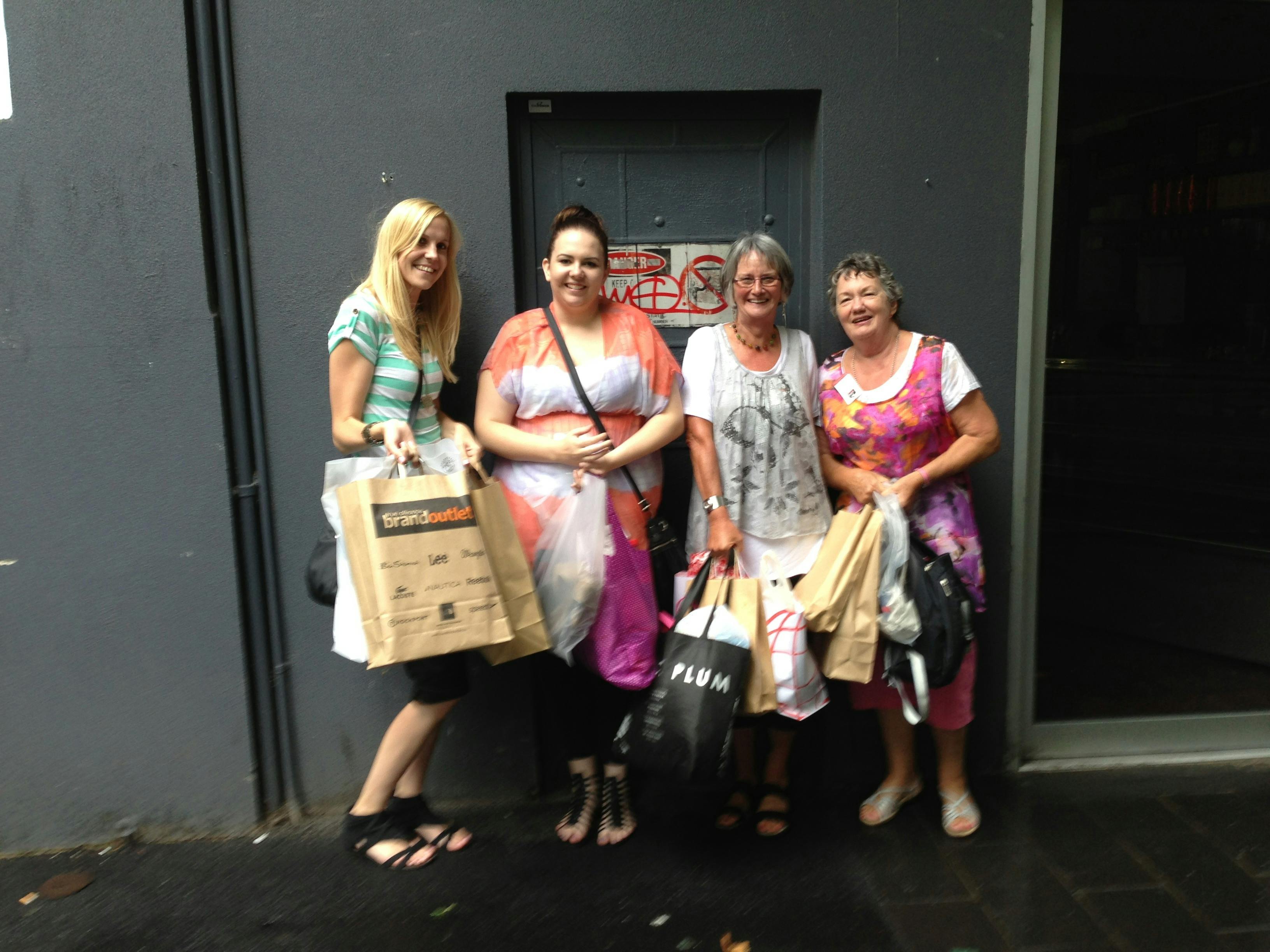 A group of women holding shopping bags