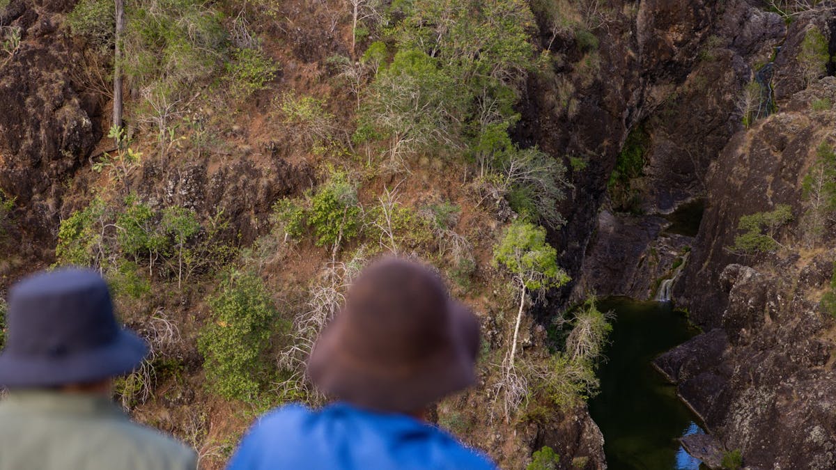 Aerial view of people looking down at kinbombi falls from the lookout