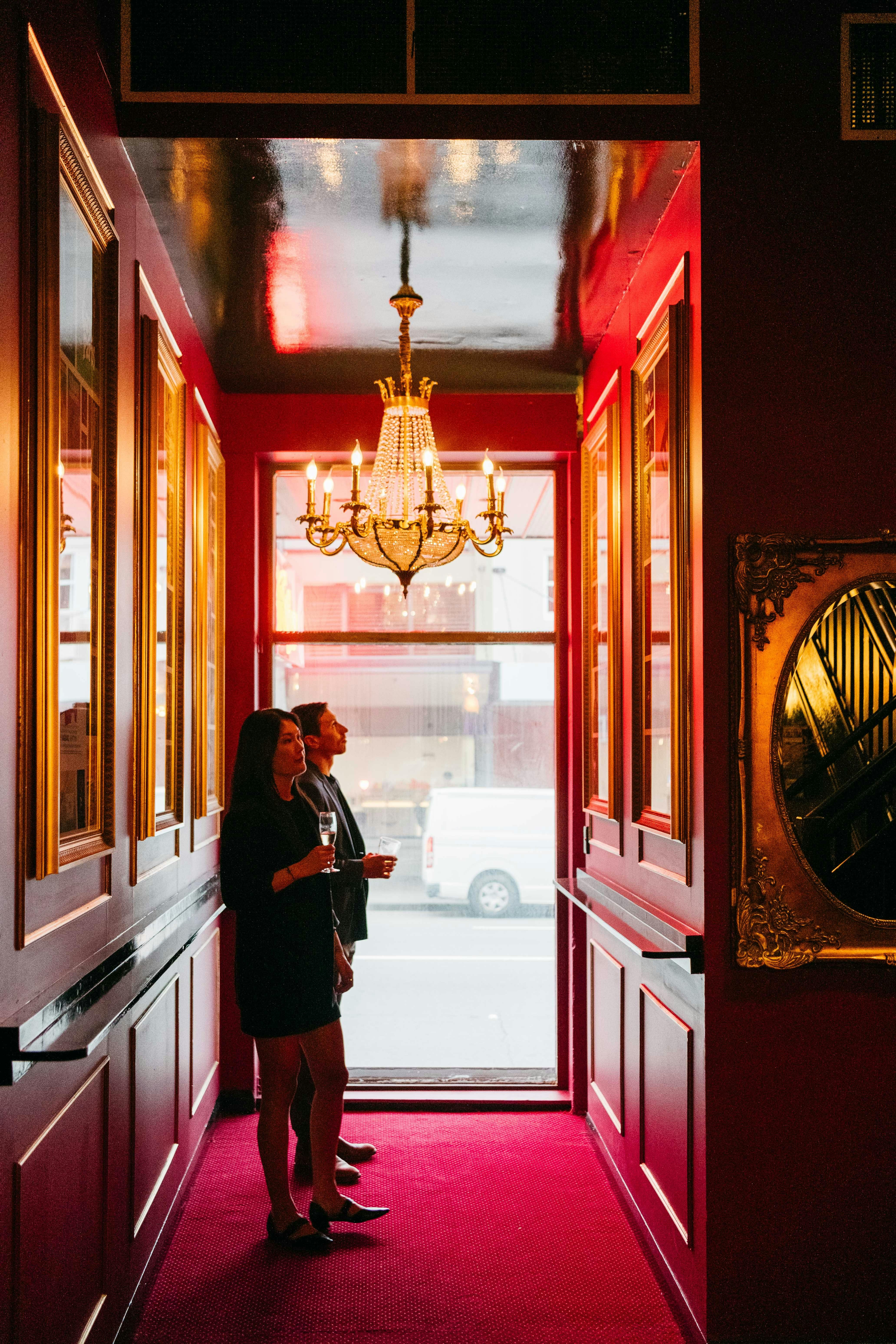 Two people looking at our previous show posters