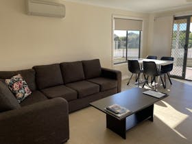 Large L shaped lounge, coffee table & dining table