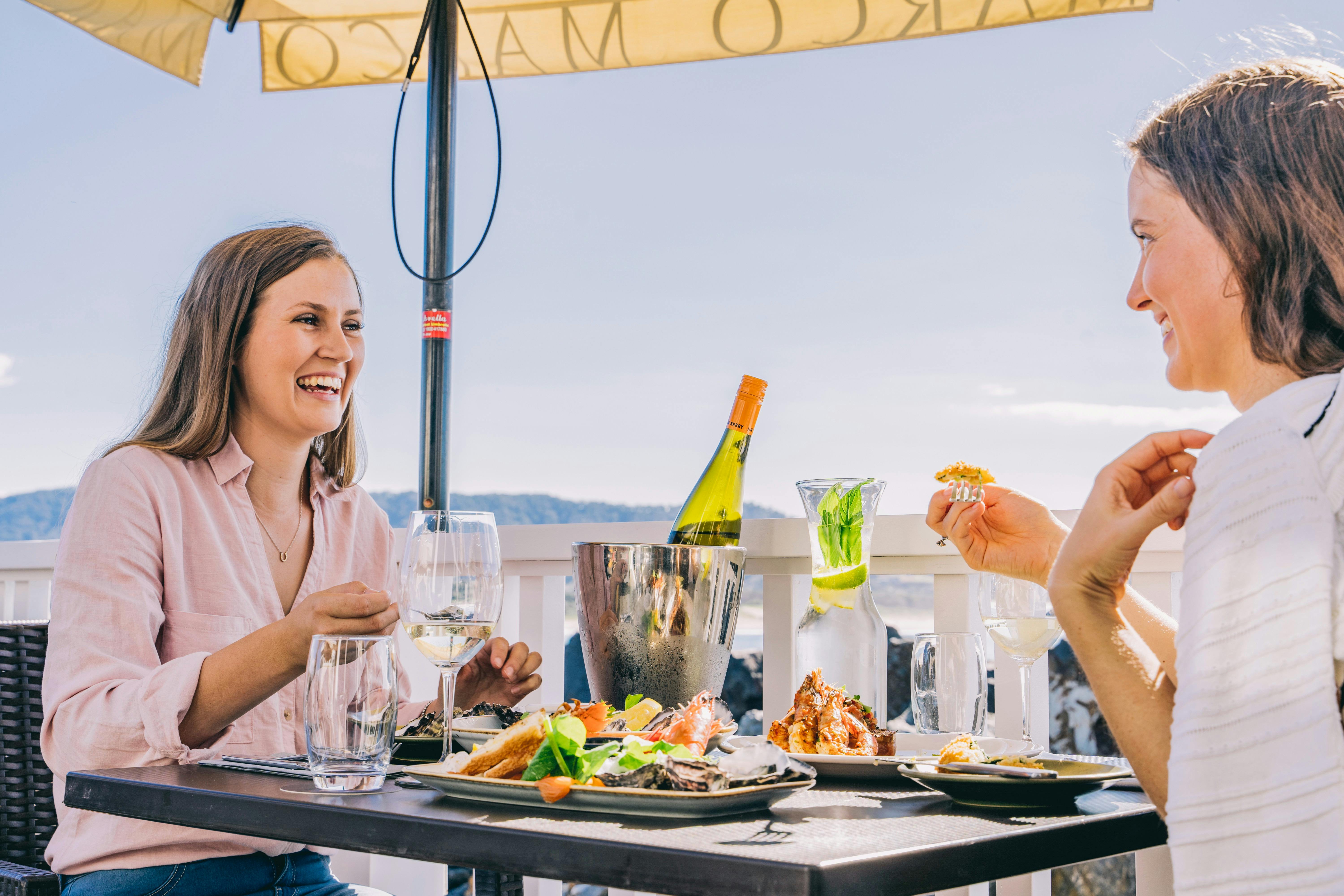 Friends enjoying food and drink at Latitude 30, Coffs Harbour
