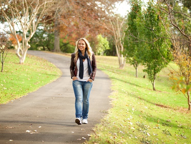 Picturesque image of a visitor to the Camden area walking along one of the paths in Macarthur Park.