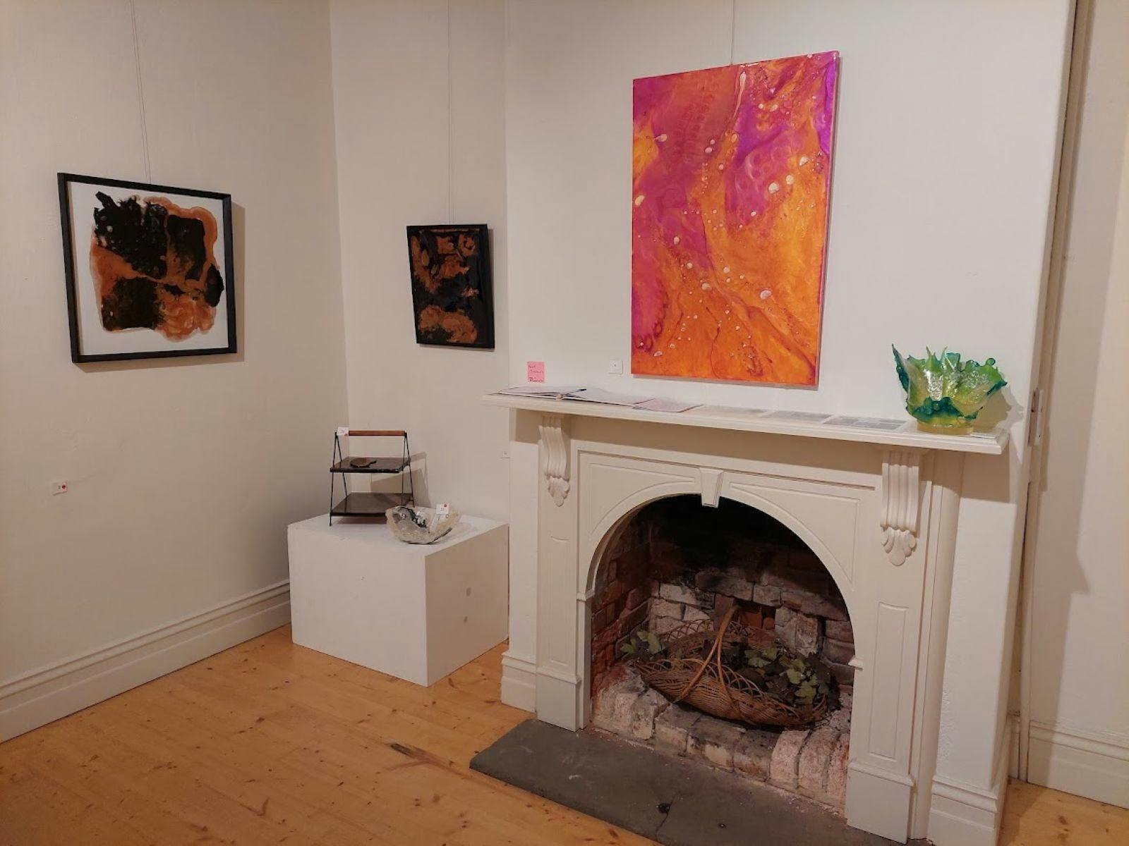 Display of Beatrice's resin artwork featuring the hot colors of pink and orange in 'Hell Fire'