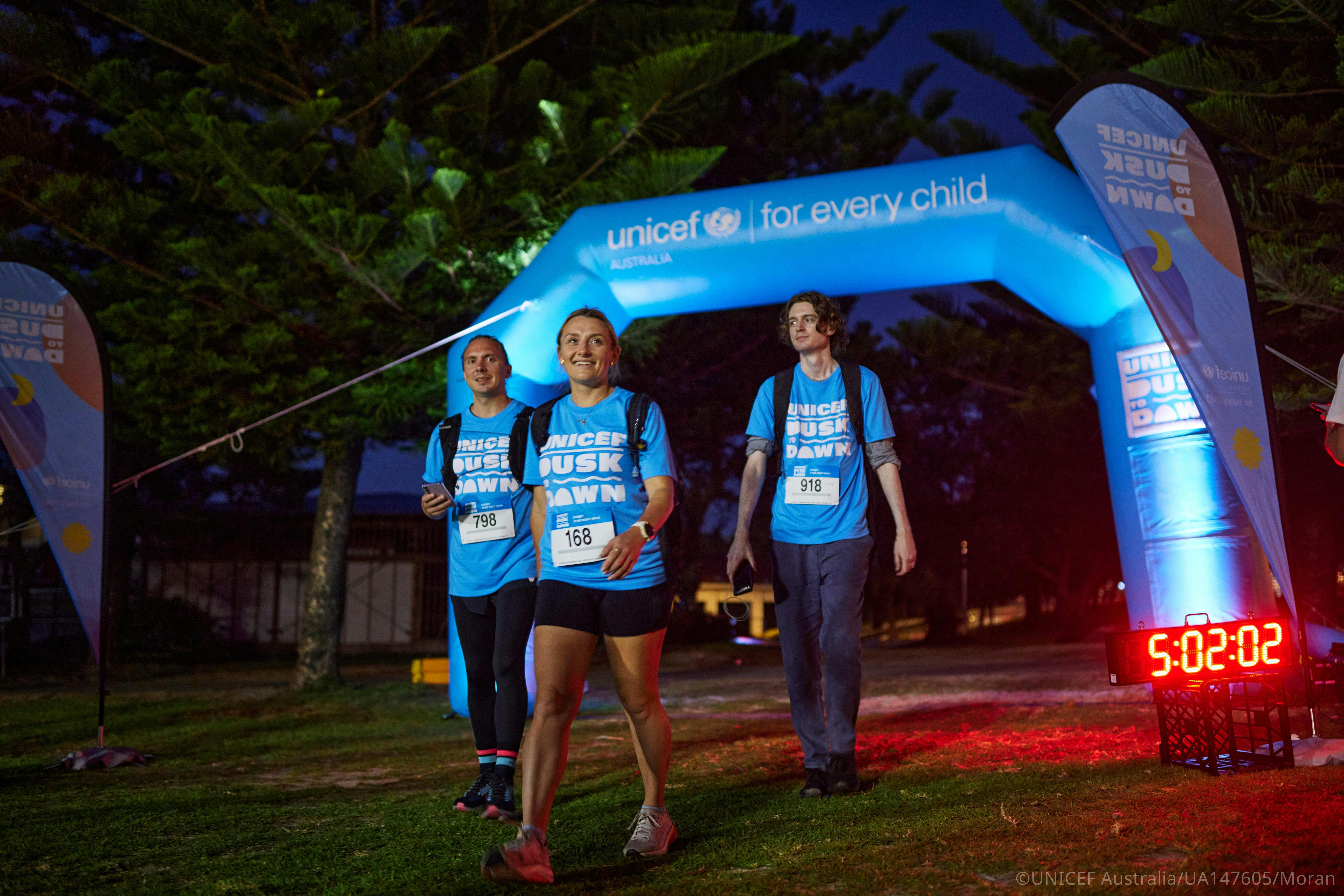 Dusk to Dawn event arch and participants along the overnight walking route.