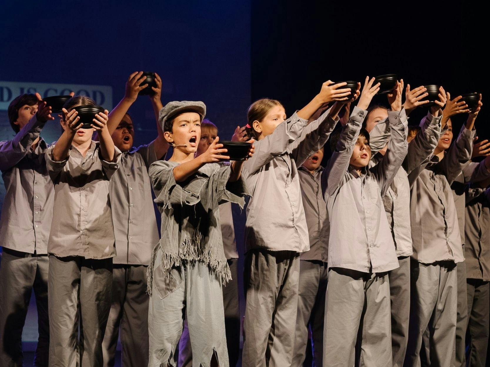 Children on stage performing Oliver