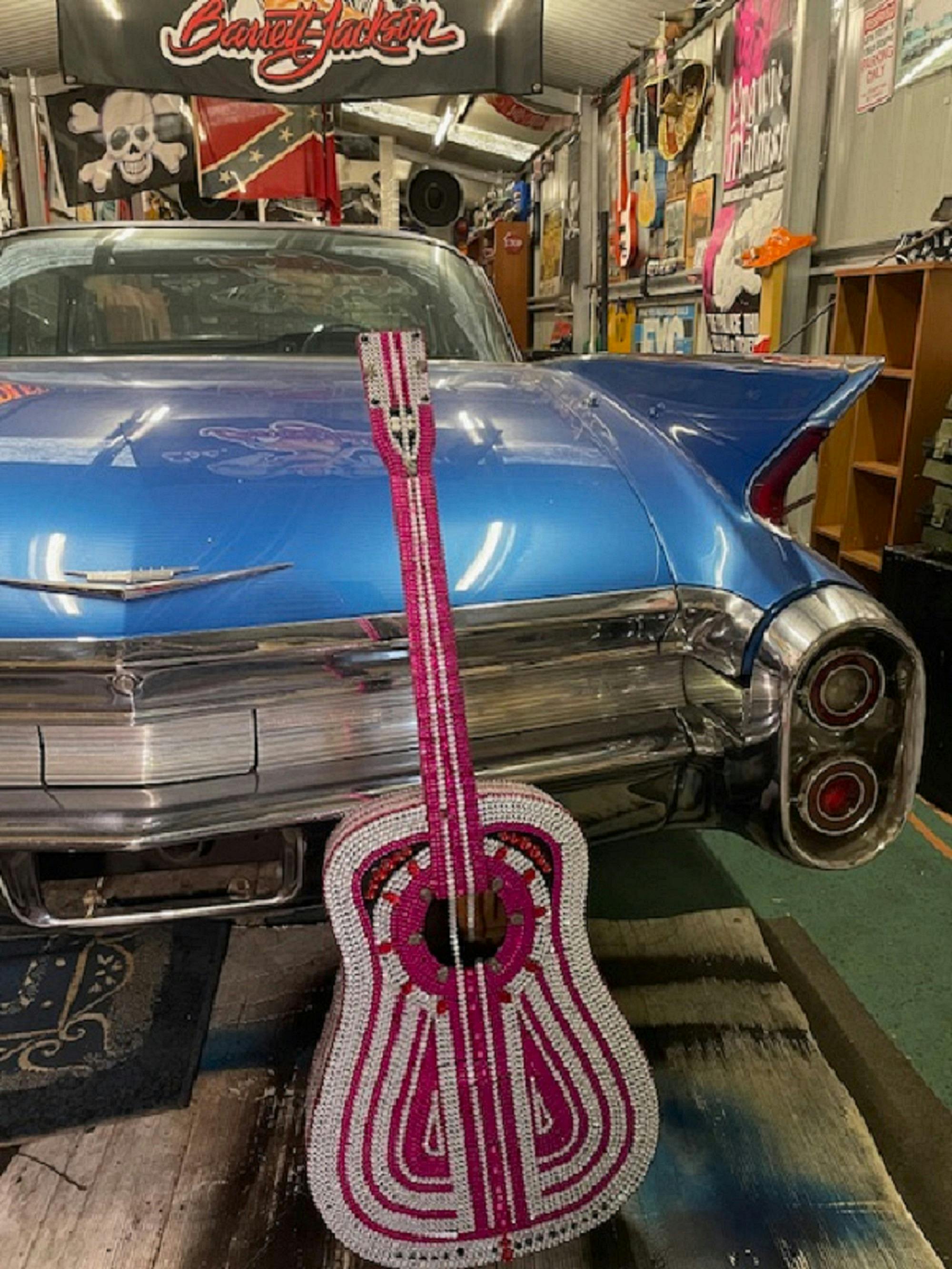 A pink rhinestone guitar
