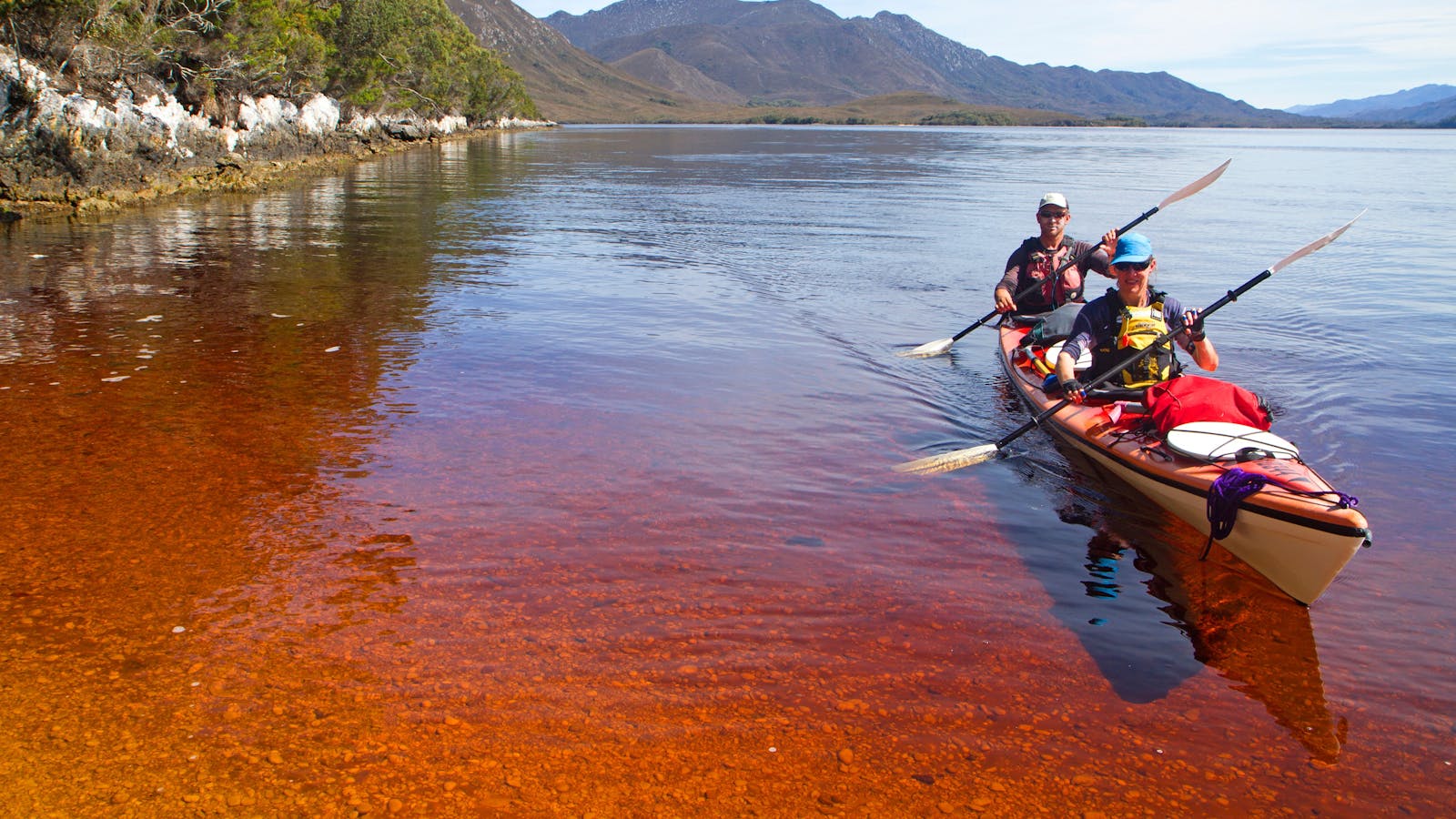 Kayakers in Bathurst Channel, Southwest Tasmania