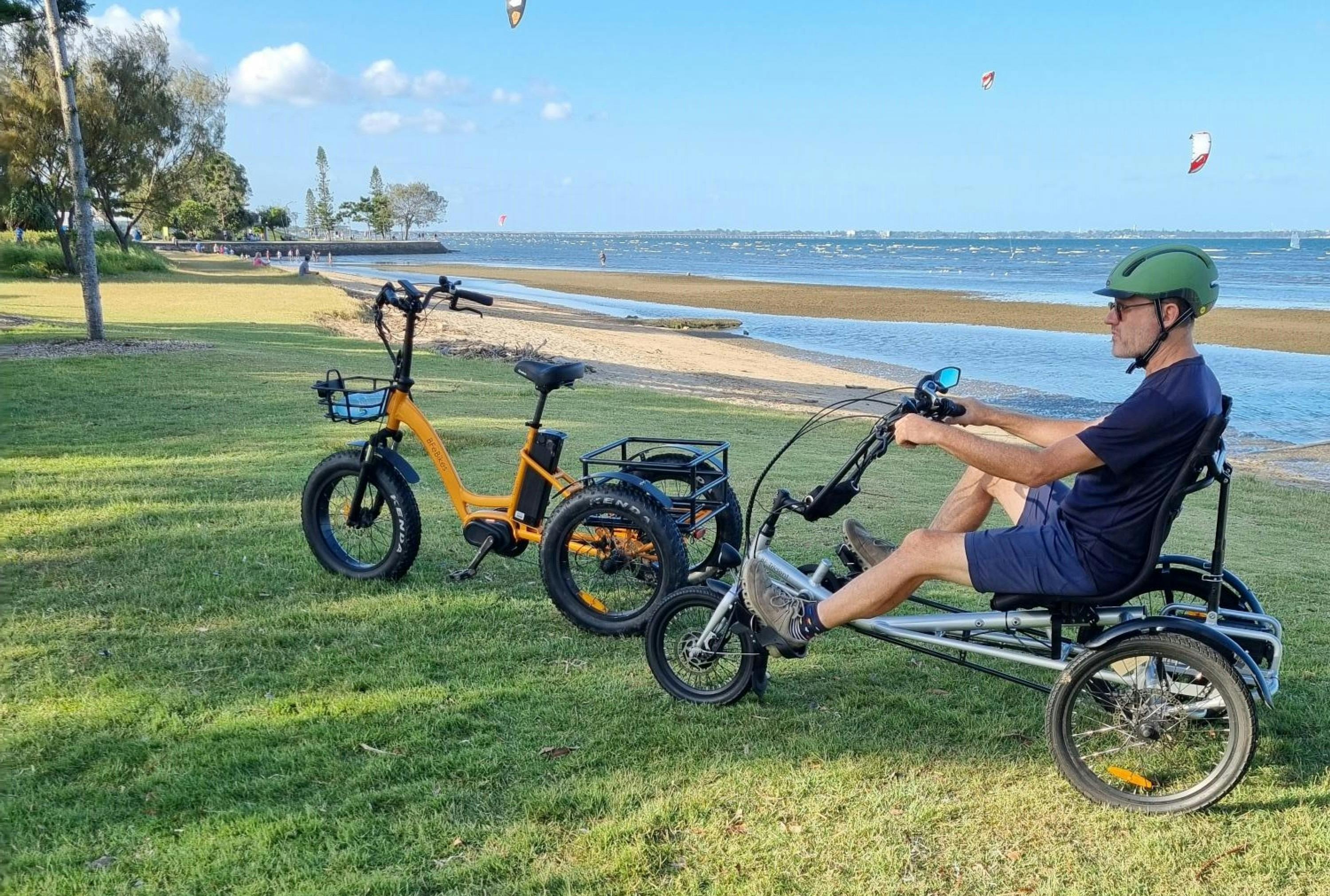 Man sitting on trike near coast