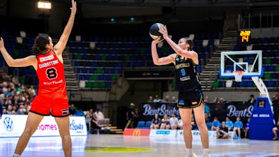 UC Capitals player shooting the basketball while a defender closes in.