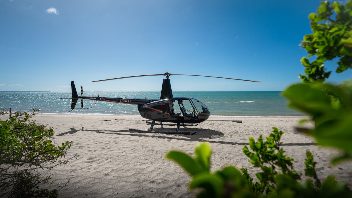 Coastal Rotors helicopter parked on Punsand Bay Beach, Cape York, ready to take flight. Coastal Rotors helicopter parked on Punsand Bay Beach, Cape York, ready to take flight.