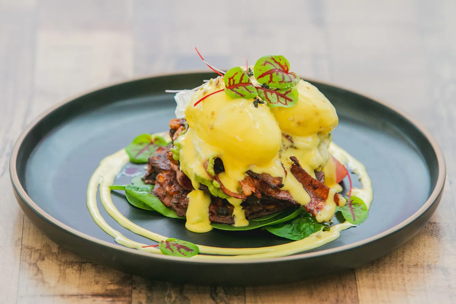 Gluten free breadless eggs benedict with poached eggs and hollandaise served on corn fritters