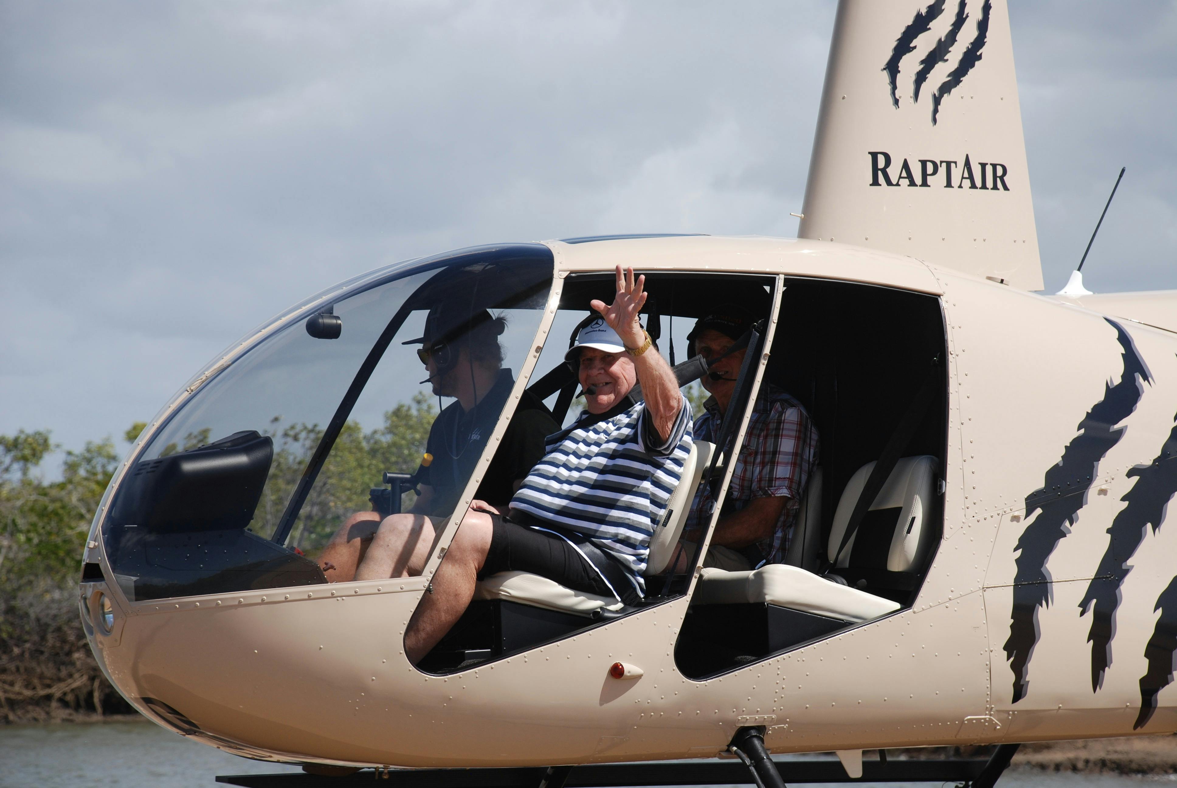 the guests are sitting in the helicopter waving out of the window -  flying with no doors
