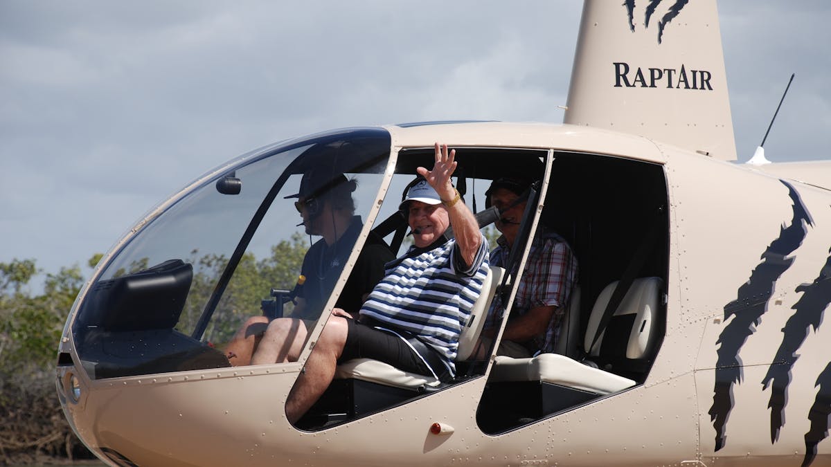 the guests are sitting in the helicopter waving out of the window -  flying with no doors