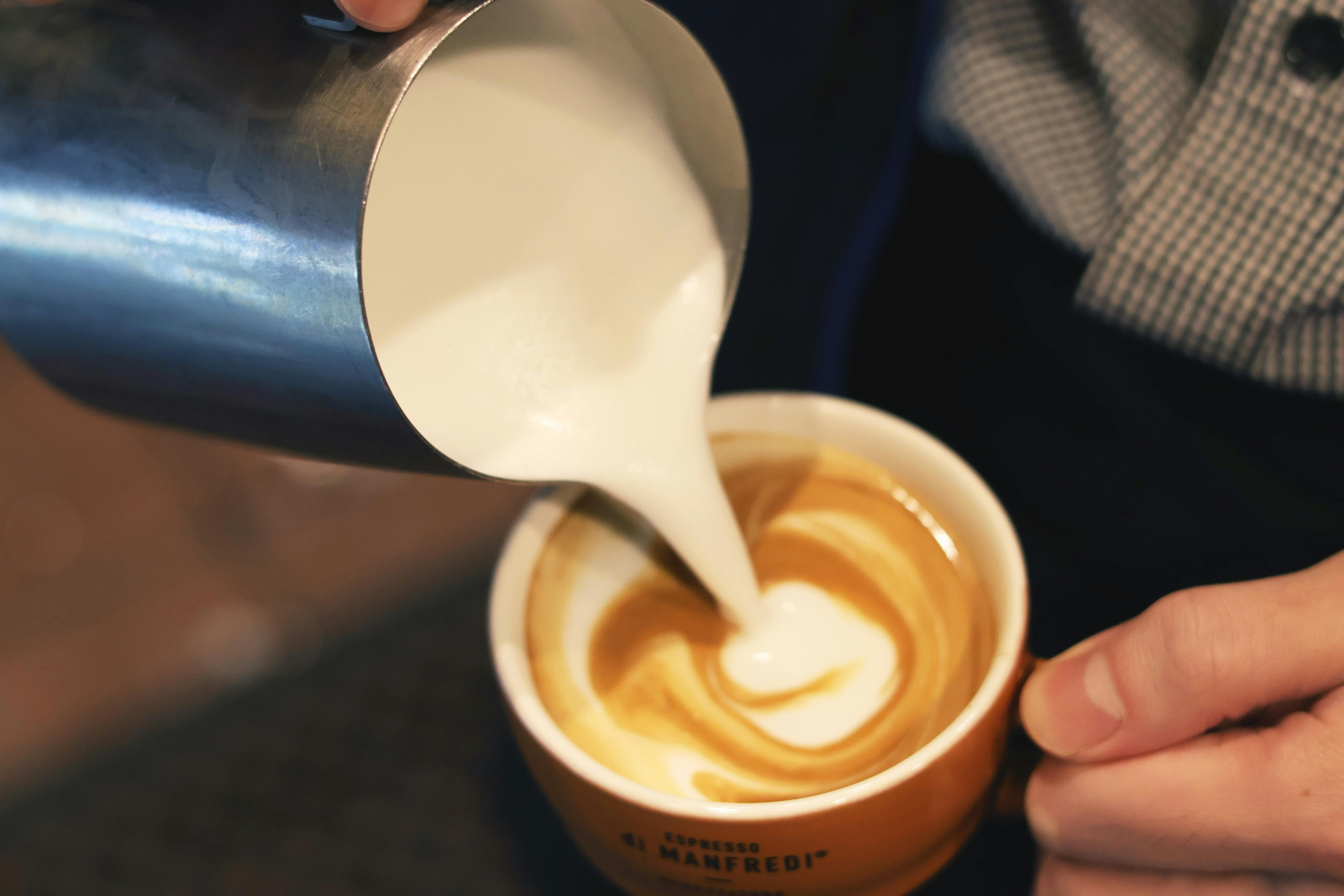 Milk pouring into coffee