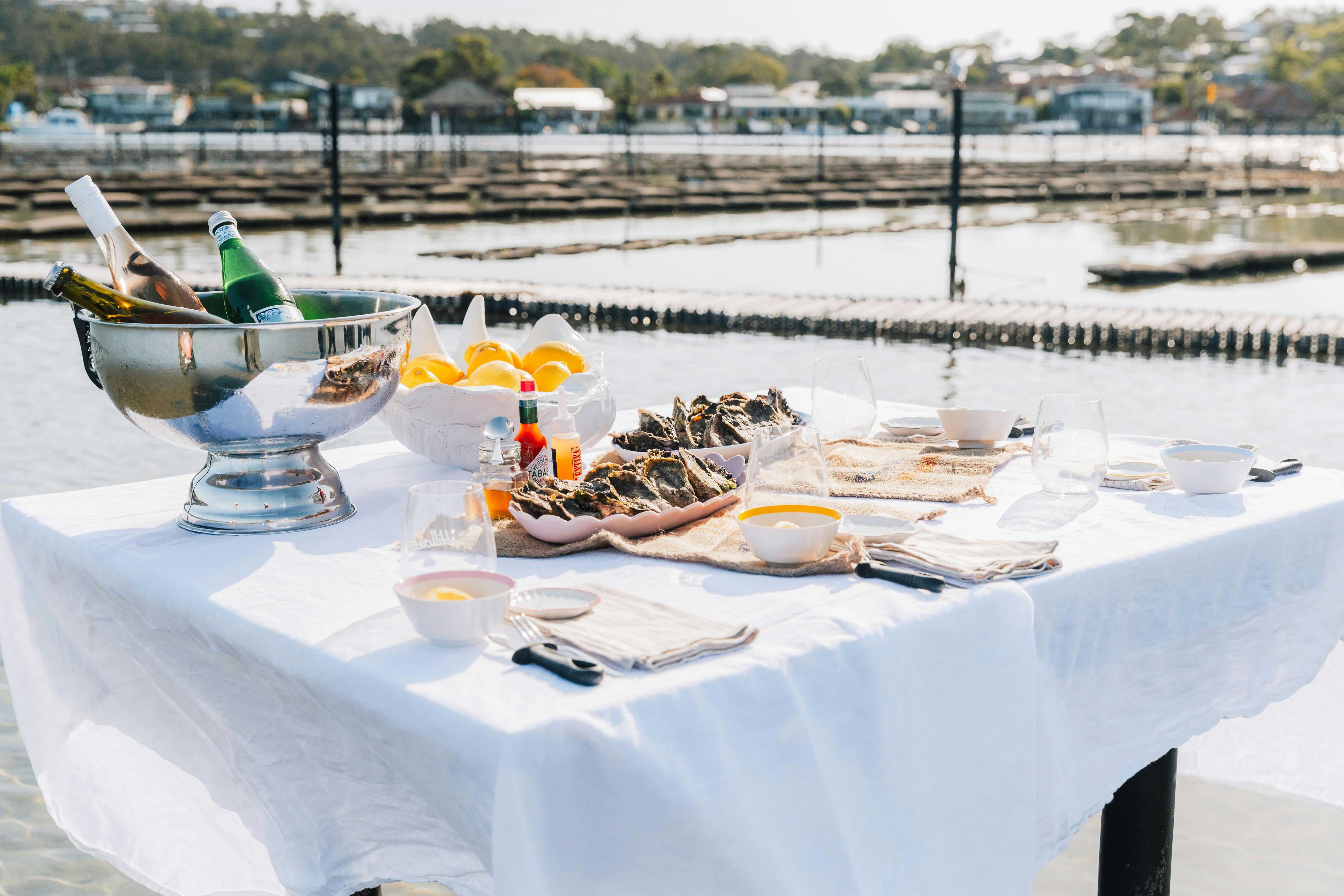 A table set on the lake ready for a oyster shucking masterclass