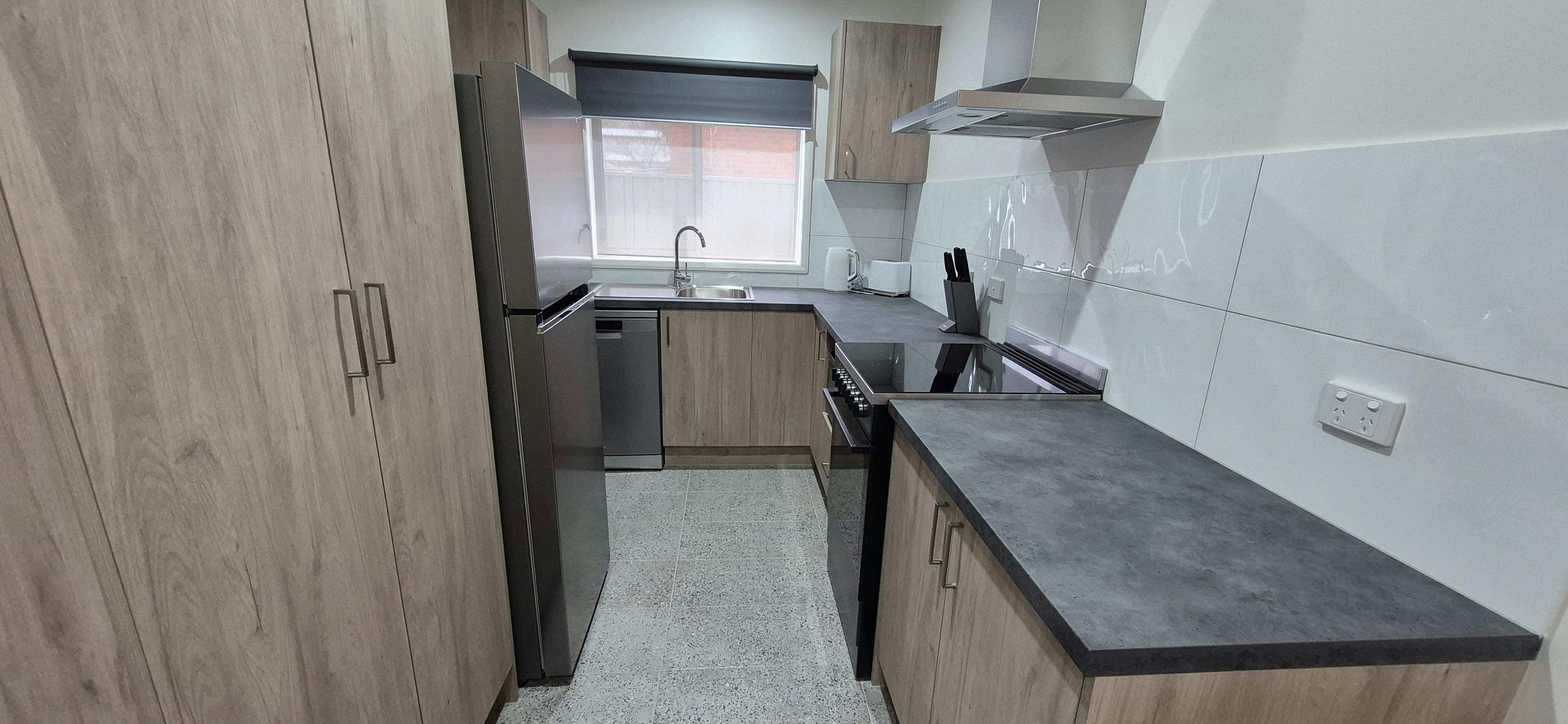Fully equipped kitchen with dishwasher, oven, full size fridge
