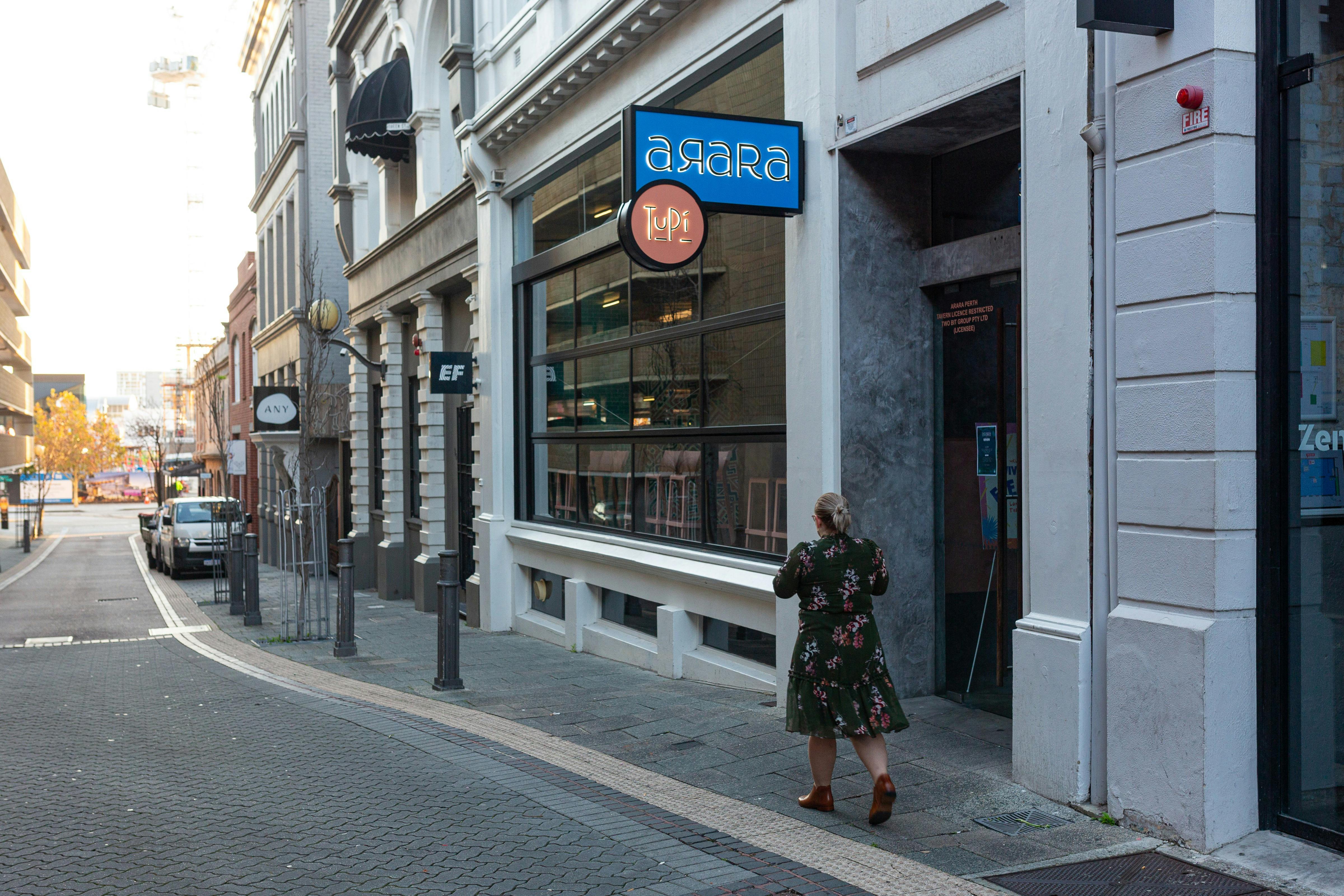 Woman walking down Perth historic Queen Street