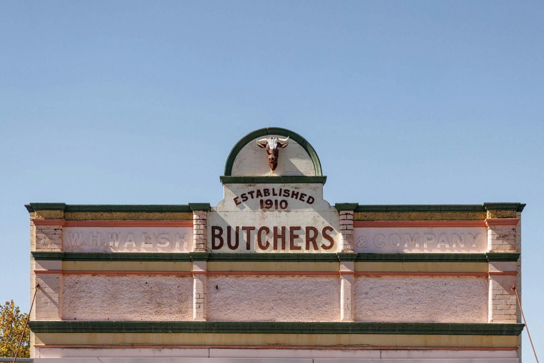 A butchers shop sign on the top of an old shop in Wolgan Street Portland NSW
