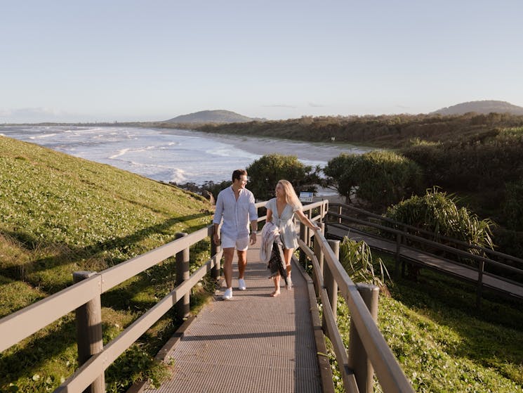 Couple walking up boardwalk