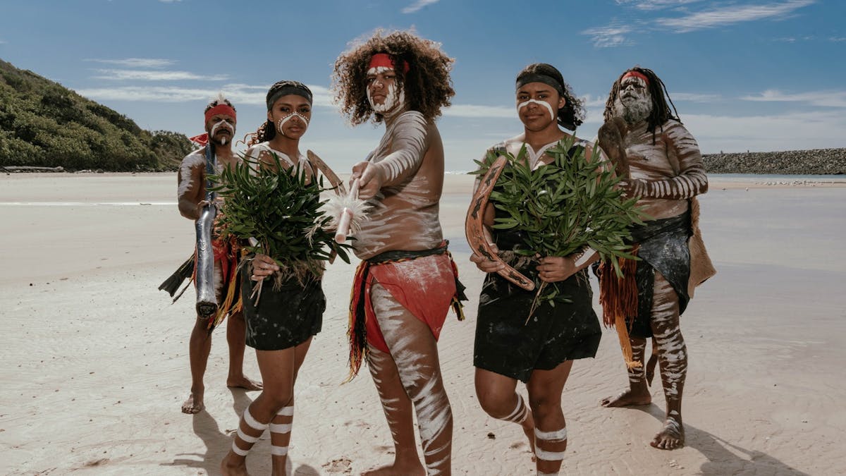 The Yugambeh Aboriginal Dancers perform on the beach during a Jellurgal Walkabout Tour