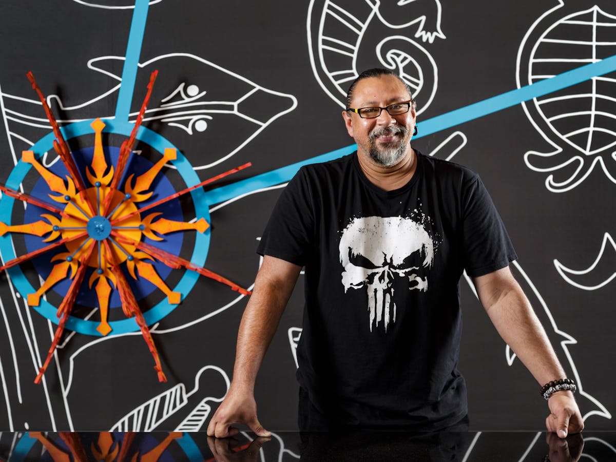 Artist Brian Robinson stands in front of his artwork