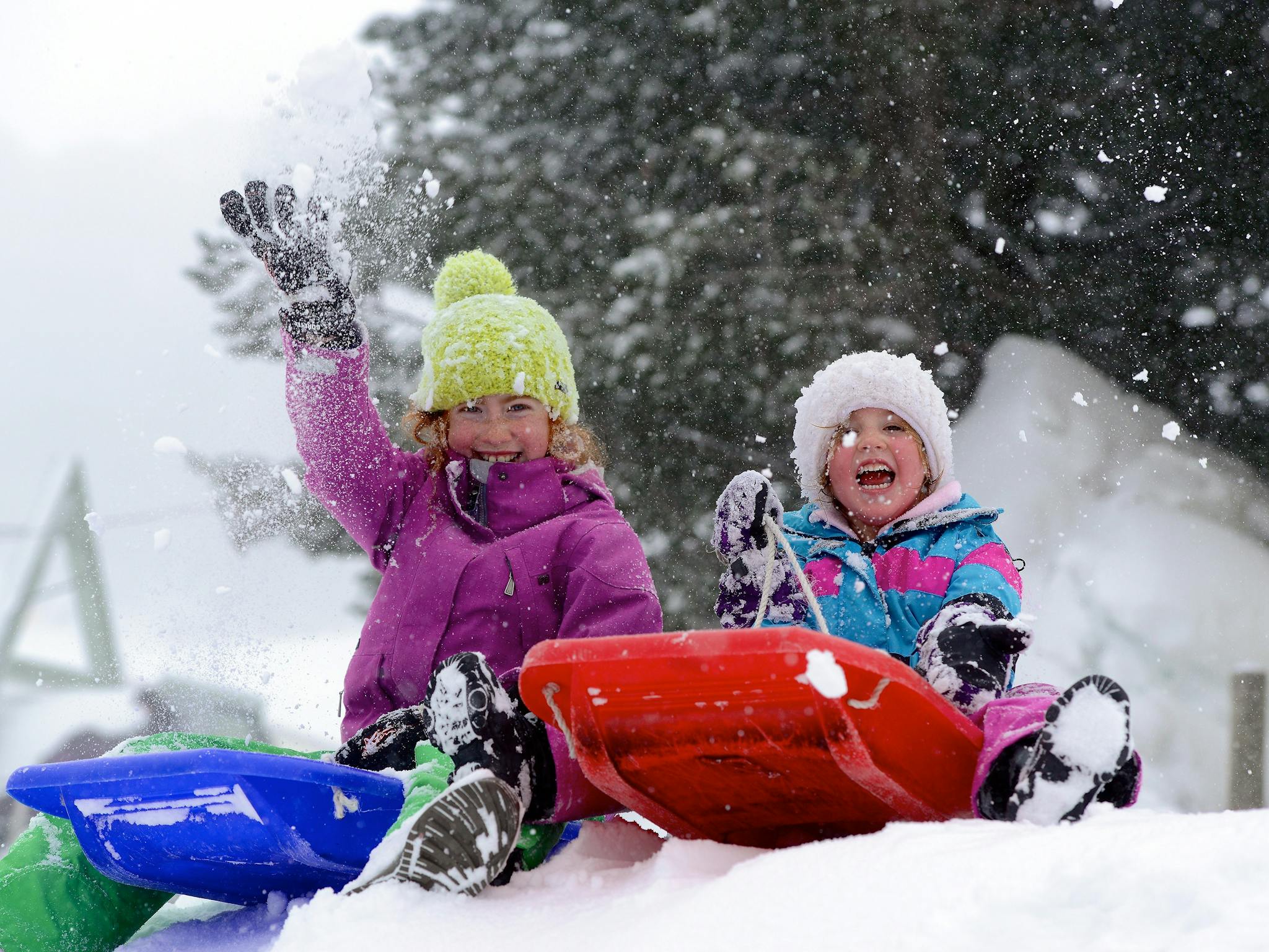 Children Tobogganing in snow