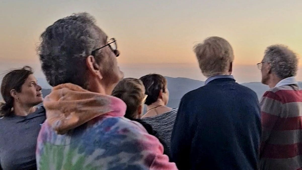Guests on a stargazing tour watching the sunset