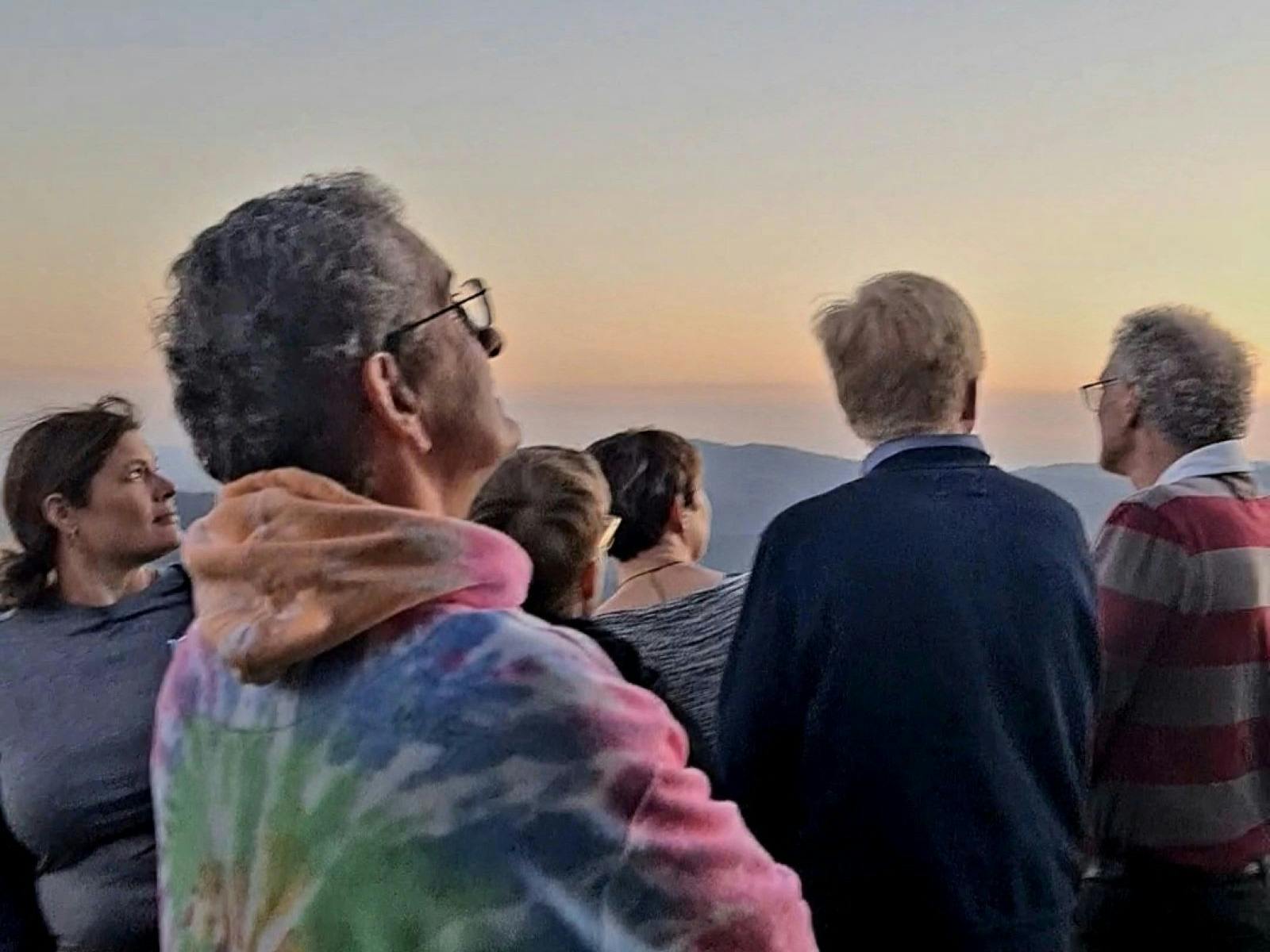 Guests on a stargazing tour watching the sunset