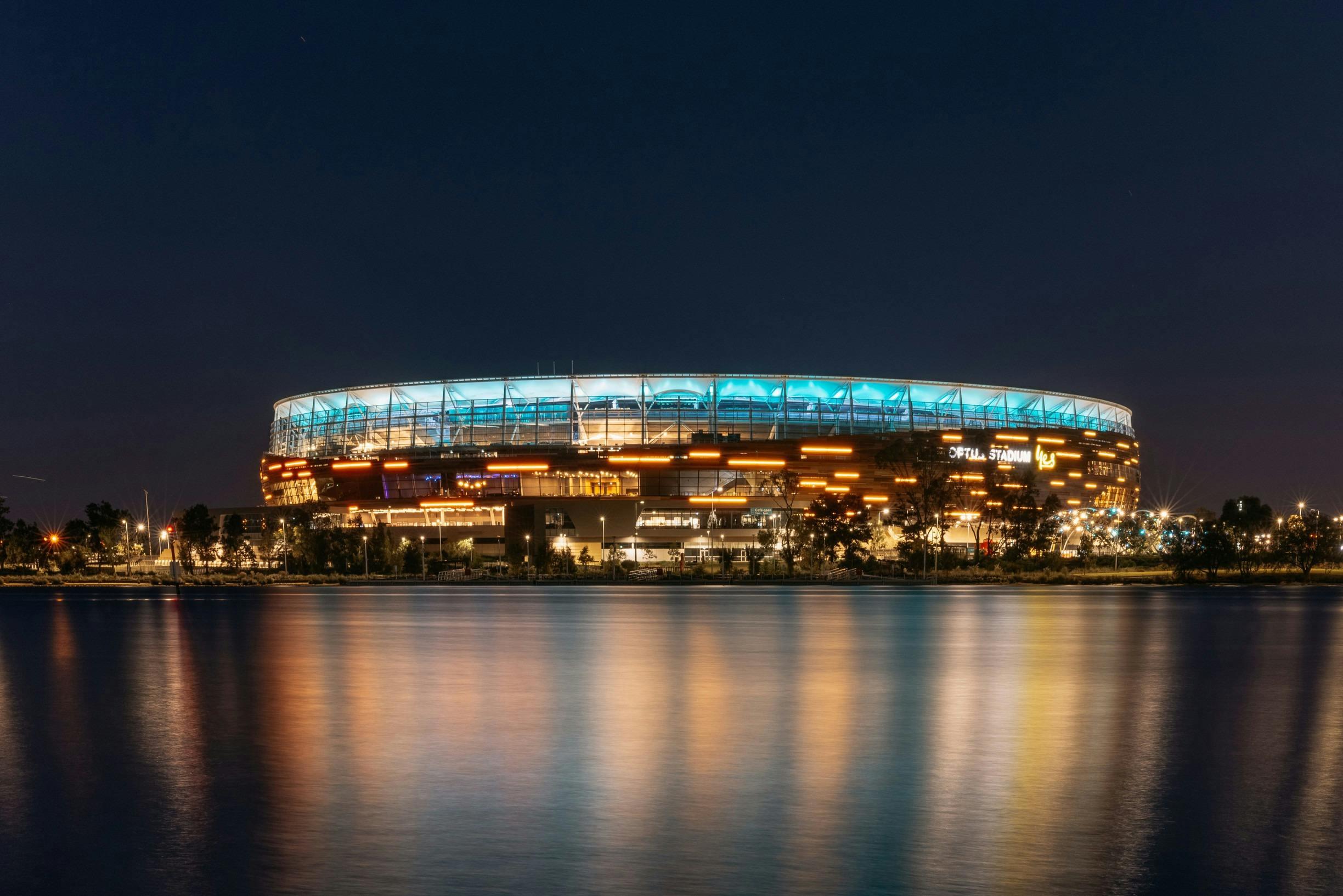 View of Optus Stadium at night from the Swan River in Burswood