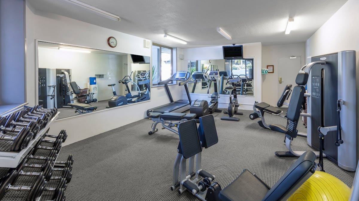 Hotel gym with mirror and equipment