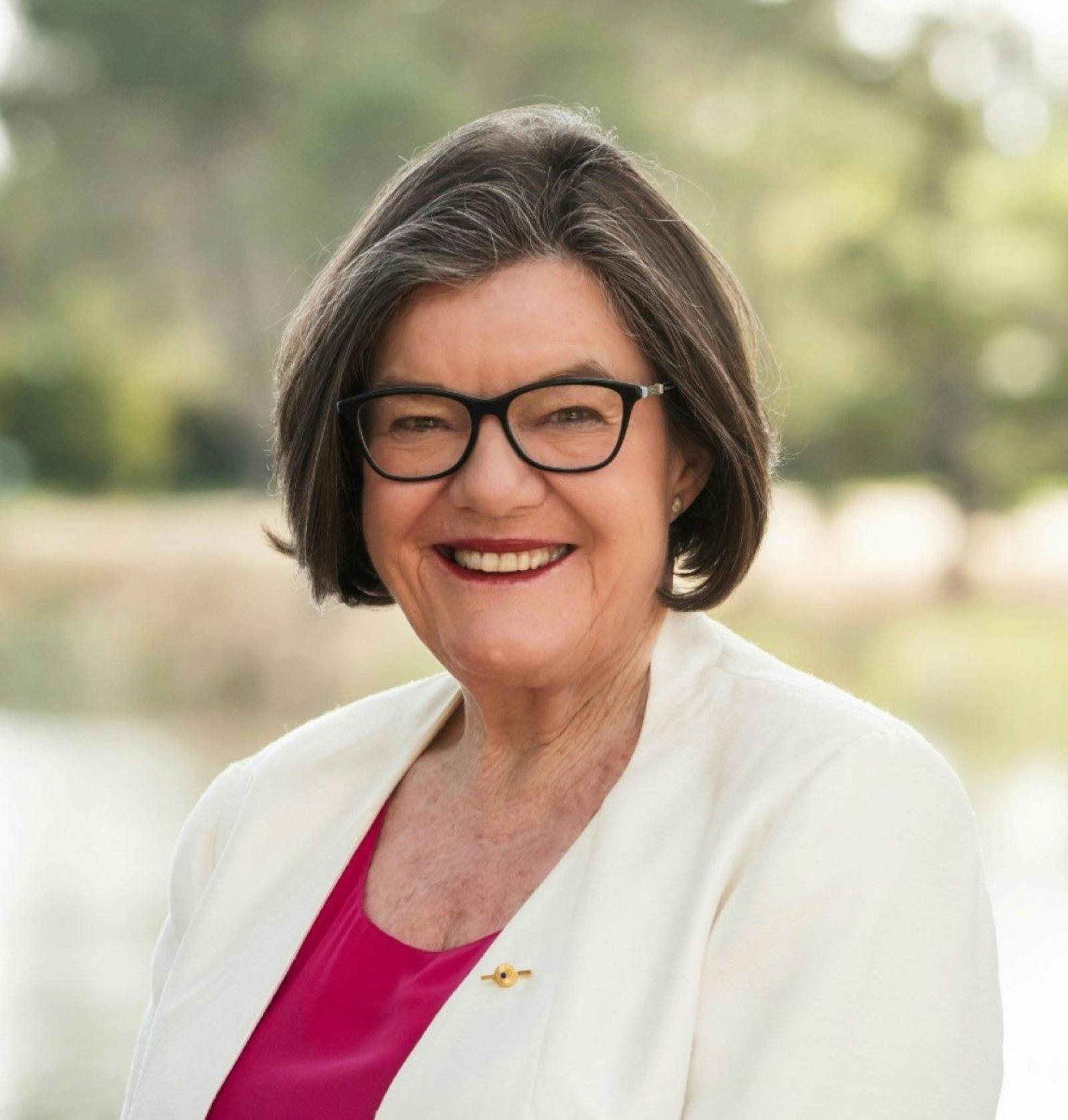 a lady facing the camera and smiling