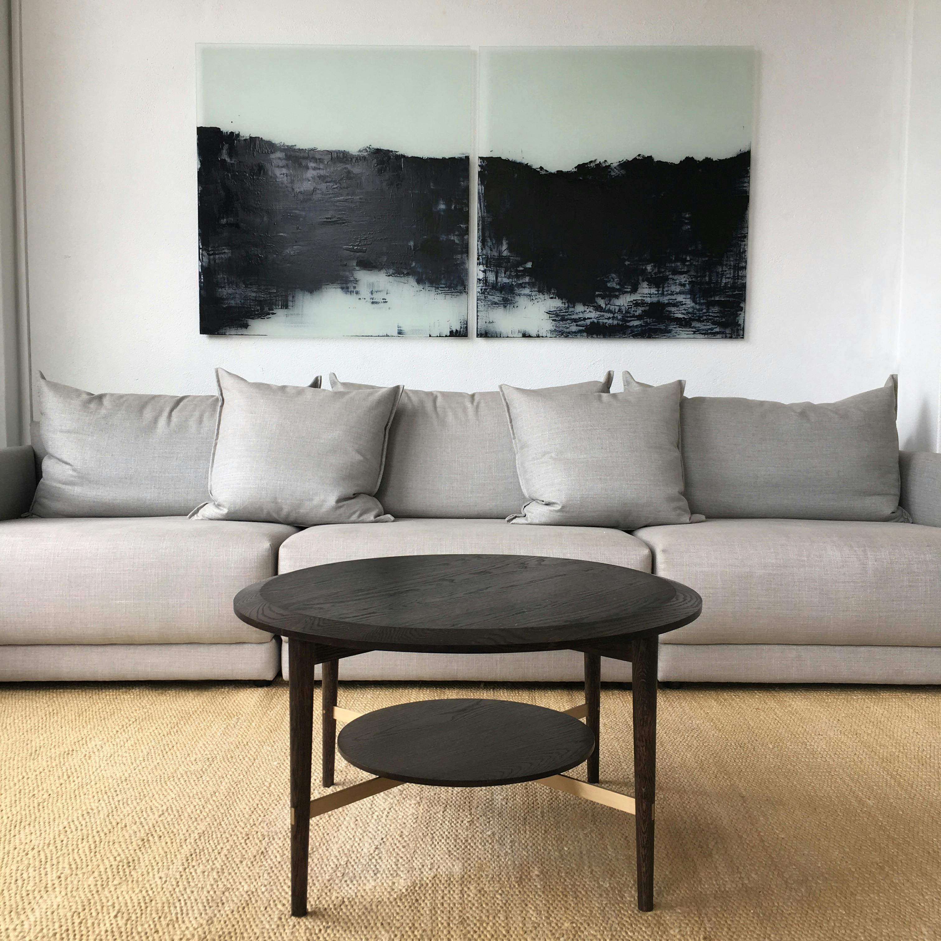 Grey sofa on a jute rug, with walnut coffee table.