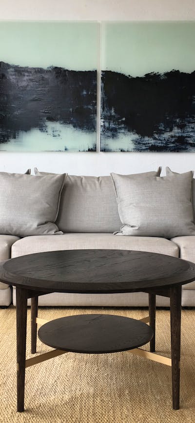 Grey sofa on a jute rug, with walnut coffee table.