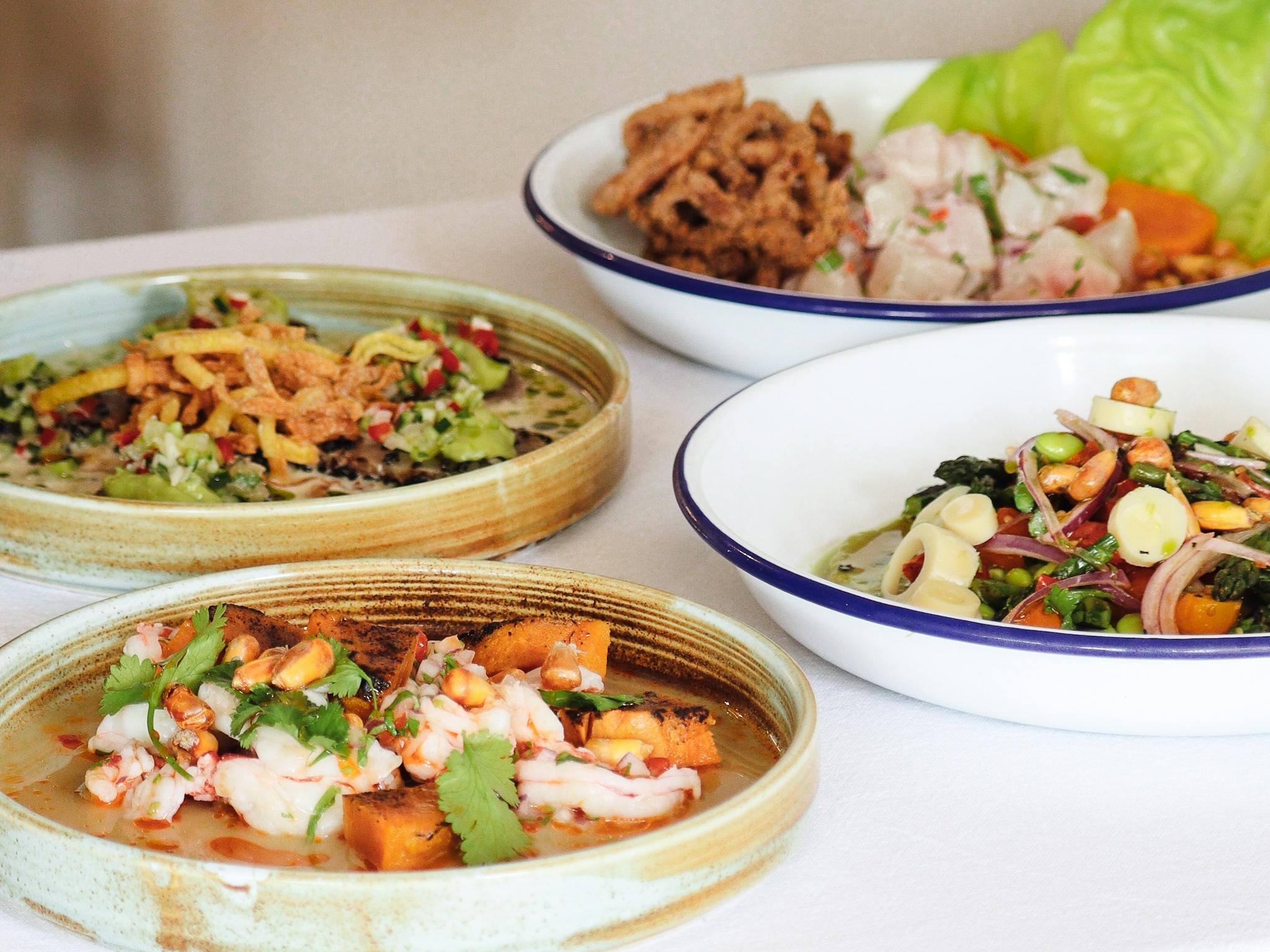 Image of four assorted seafood dishes