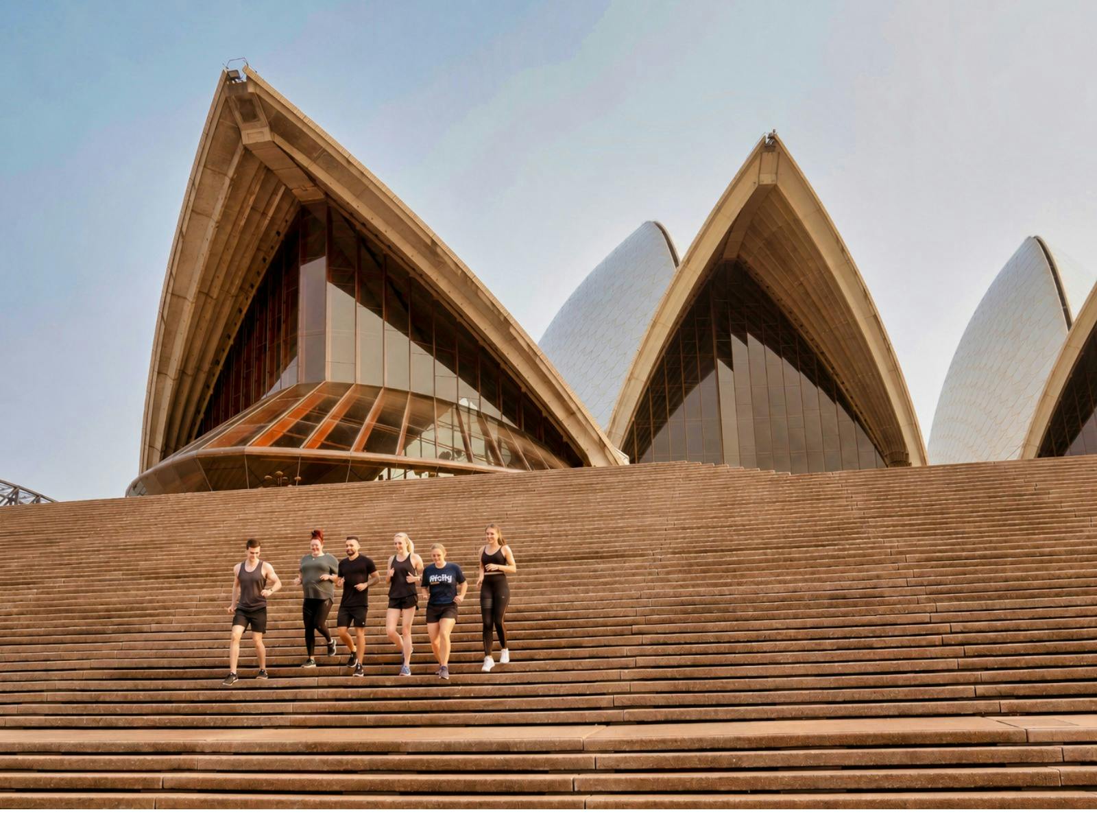 A tour group running out the front og the Sydney Opera House