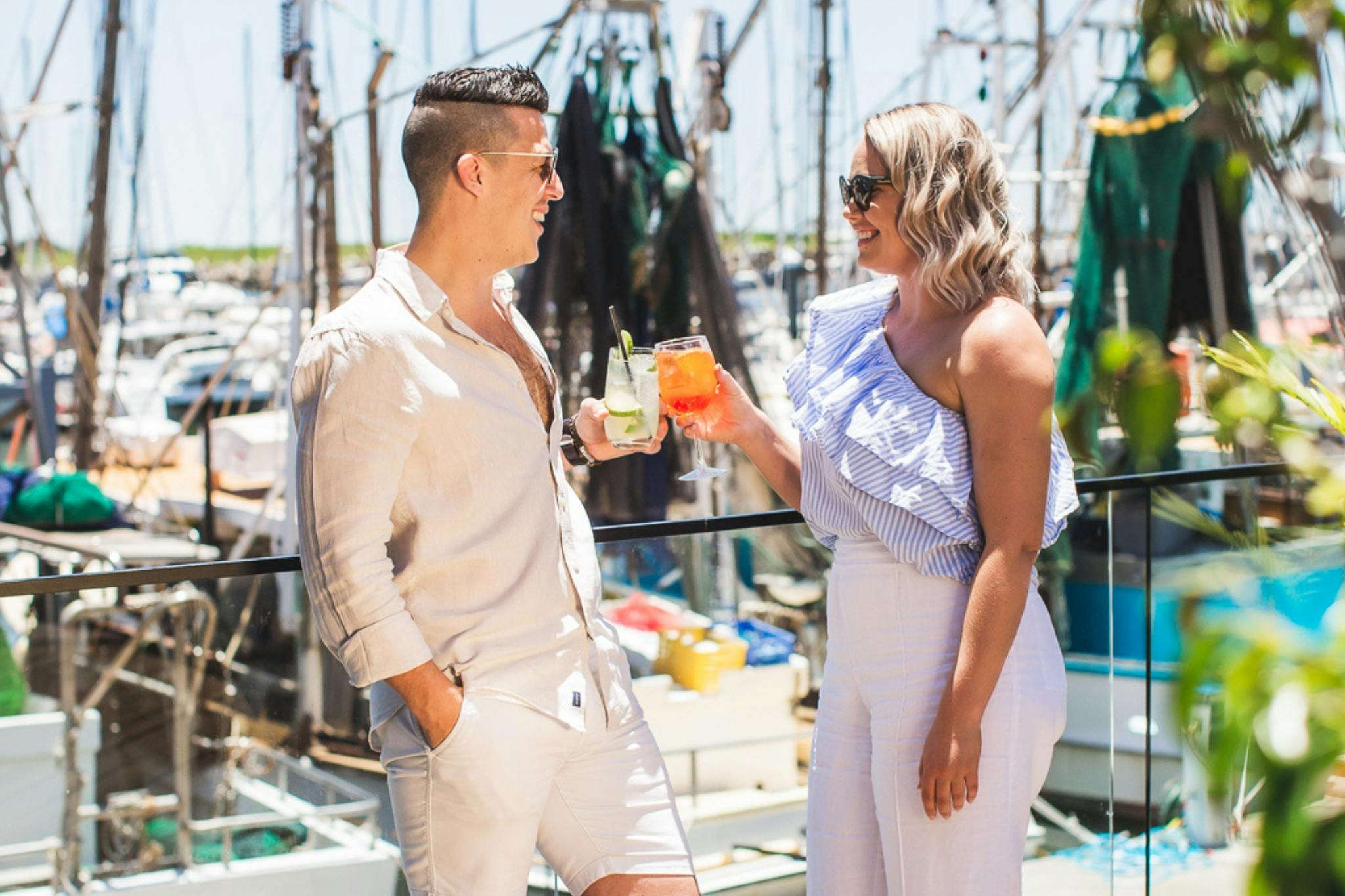 Couple enjoying cocktails together overlooking Scarborough Harbour
