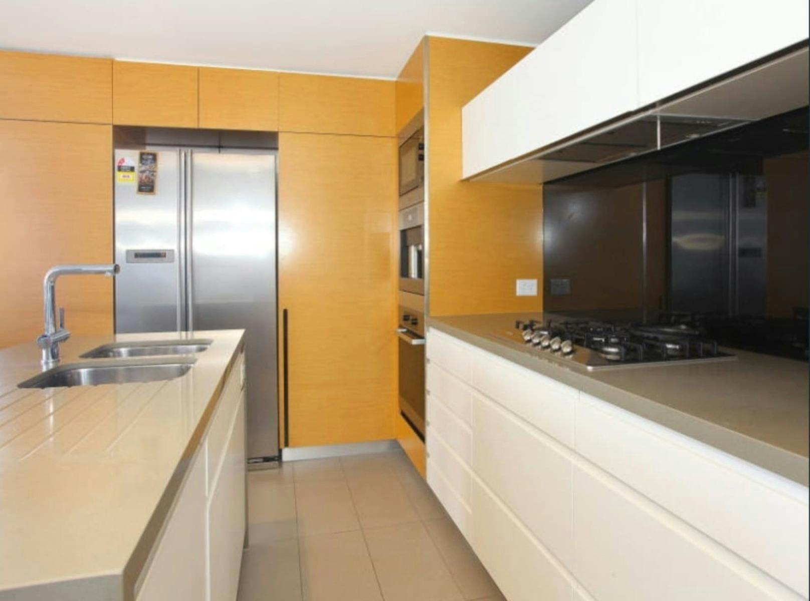 Full kitchen with island bench, Miele appliances and easy meal space