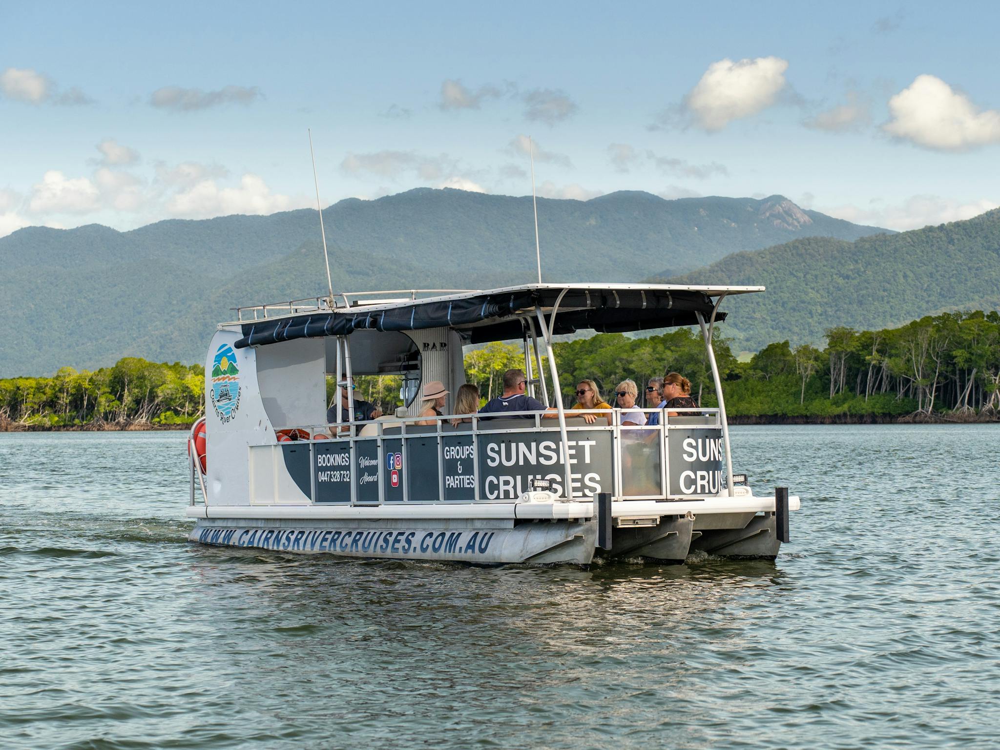 The Fitzroy One Cairns River Cruise with guests aboard sailing into the Trinity Inlet near Cairns The Fitzroy One Cairns River Cruise with guests aboard sailing into the Trinity Inlet near Cairns