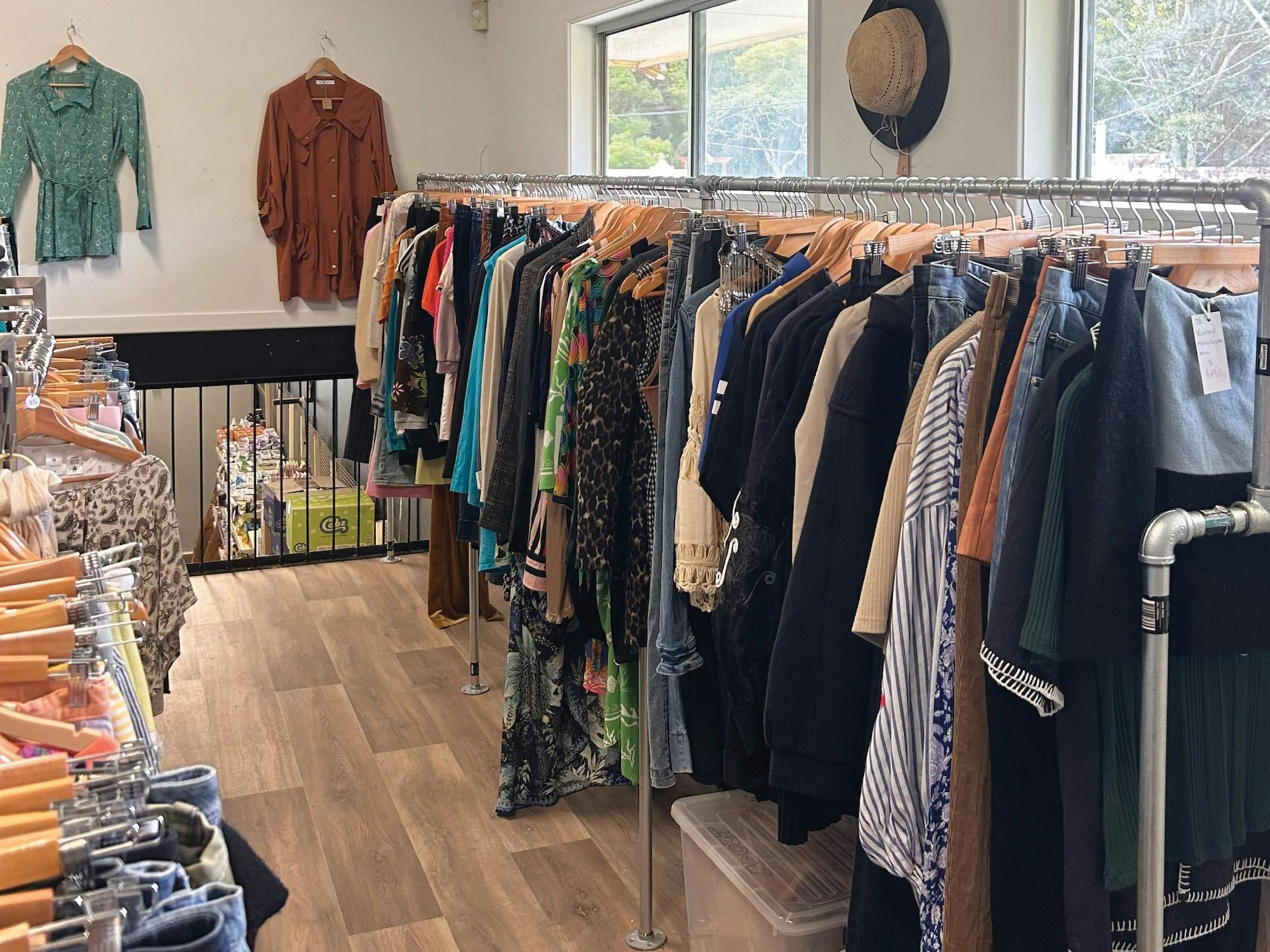 Multiple racks with clothing on them within the space.
