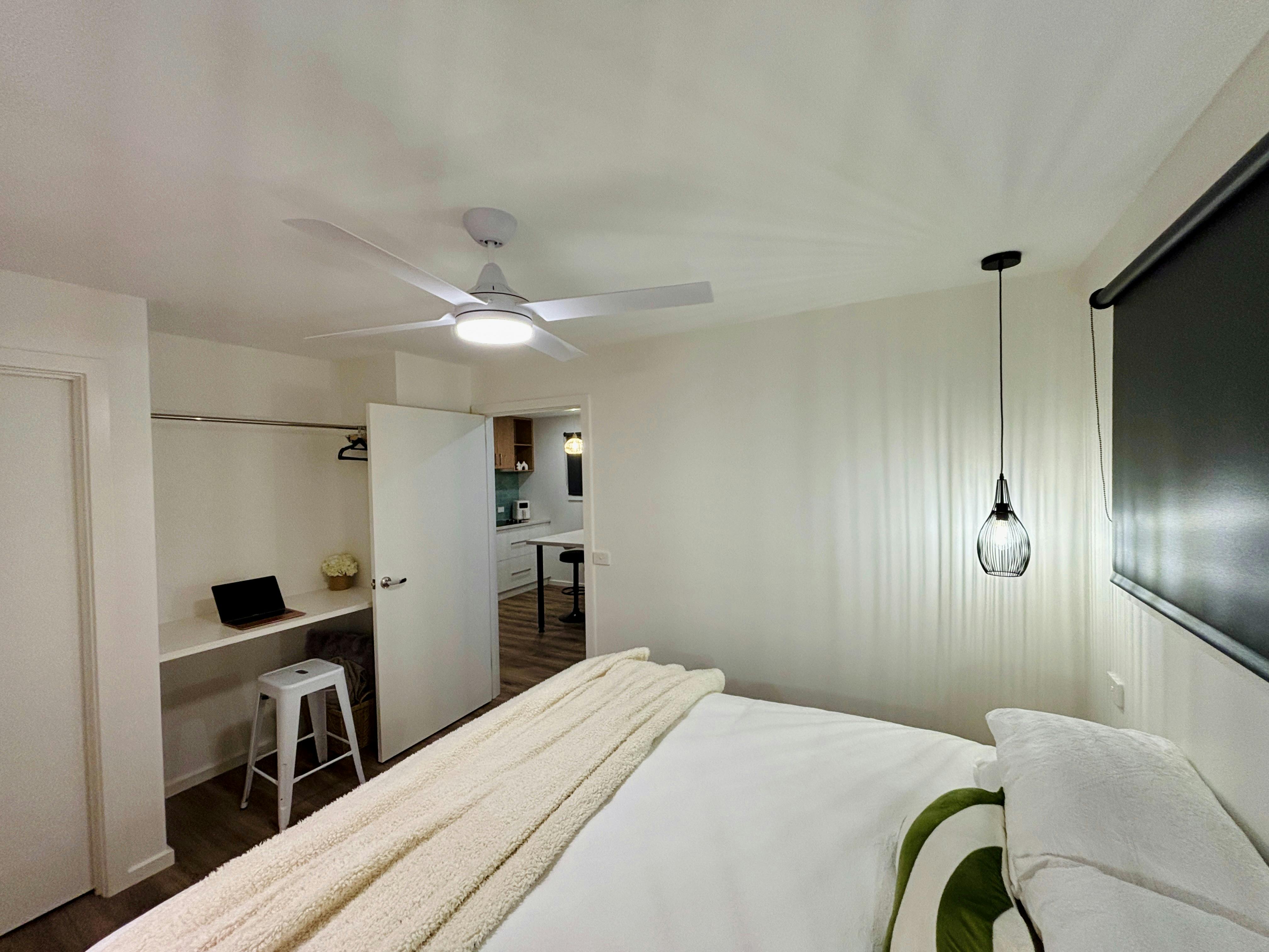 Bedroom has a desk and an area to hang your clothes